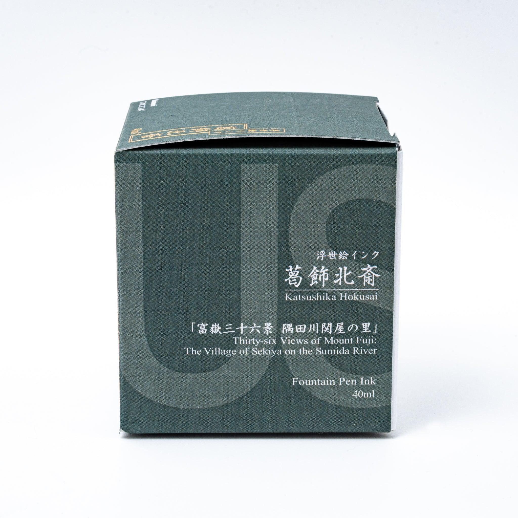 Hokusai sabimidori ink with box displaying traditional Japanese woodblock artwork on neutral white background surface