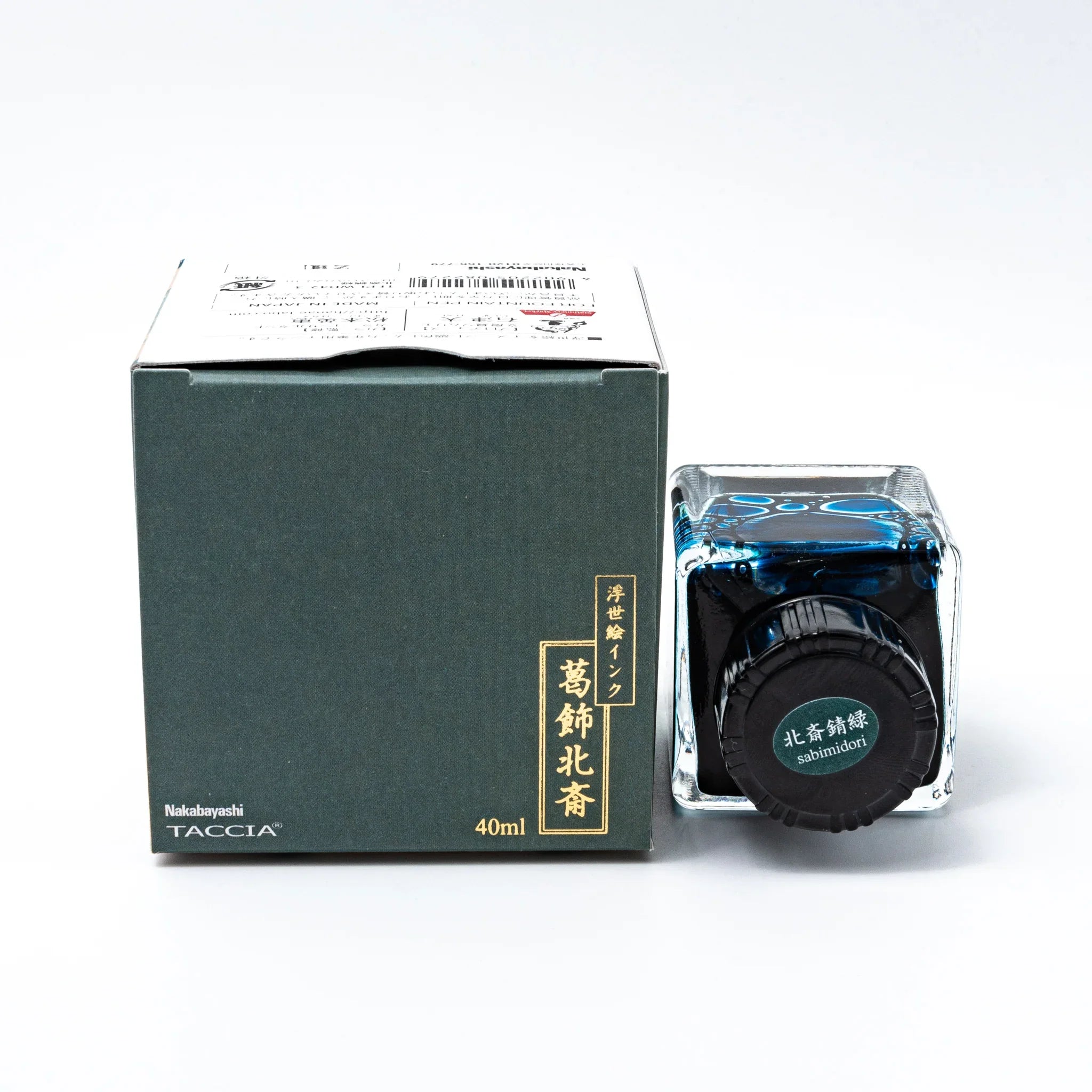 TACCIA Hokusai Sabimidori ink set displaying decorative teal box and glass bottle with black threaded cap on white