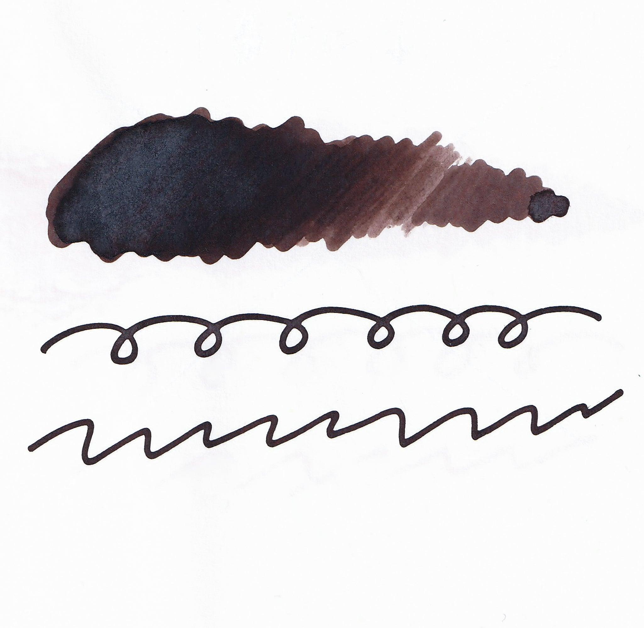 Swatch of brown fountain pen ink on white paper. The ink shows shading variations, with a dark center and lighter edges. Below are wavy and looped lines demonstrating the ink's flow.