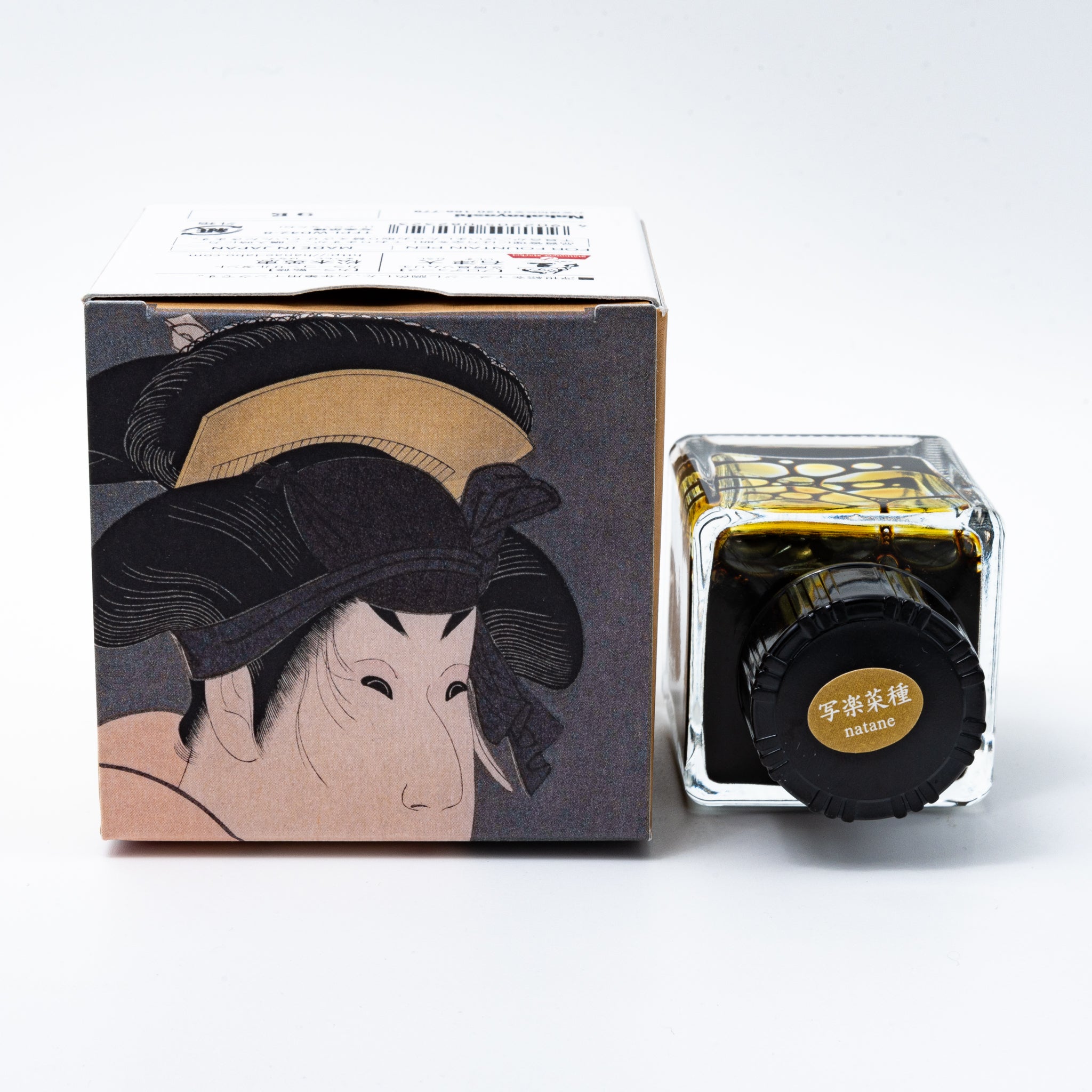 Japanese stationery fountain pen ink. The packaging features Ukiyo-e style art of a kabuki actor in a yellow kimono. The glass bottle contains 40ml of yellow "Natane" ink.