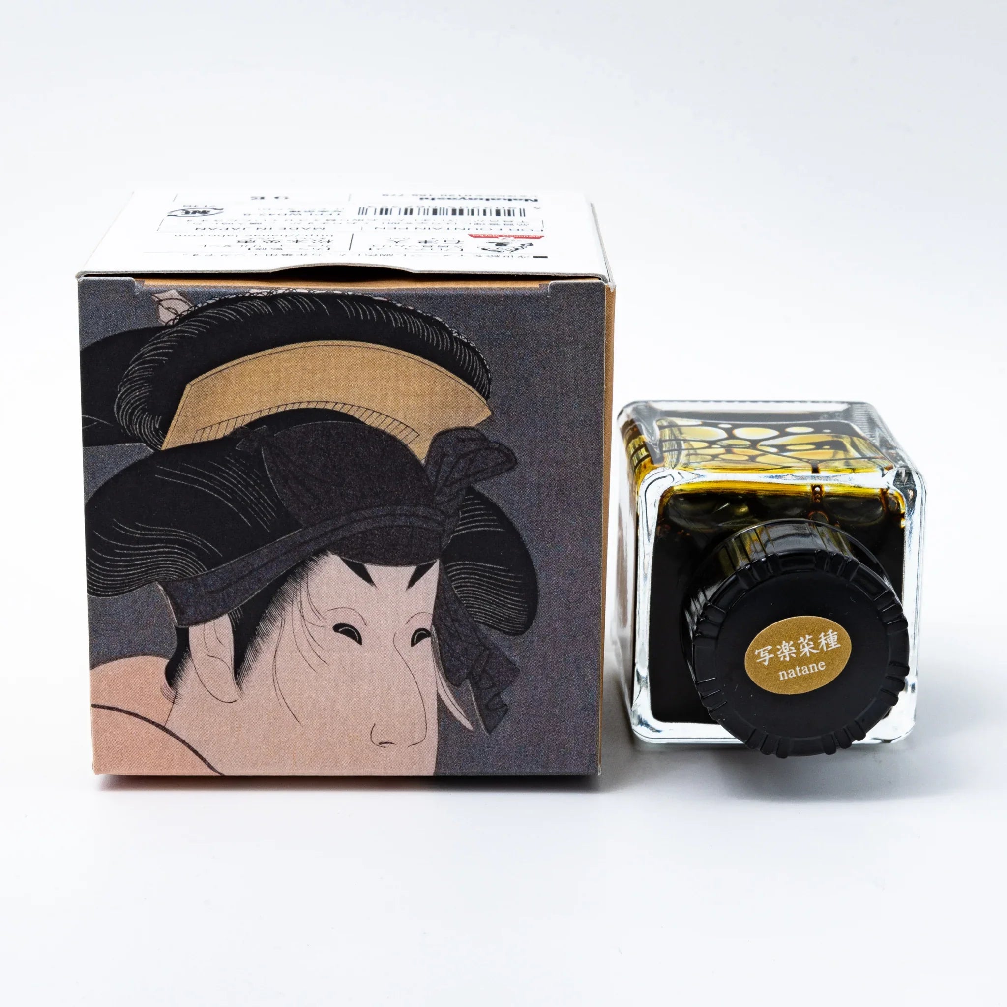TACCIA Natane golden yellow-green ink bottle with label and decorative Japanese packaging materials visible detail