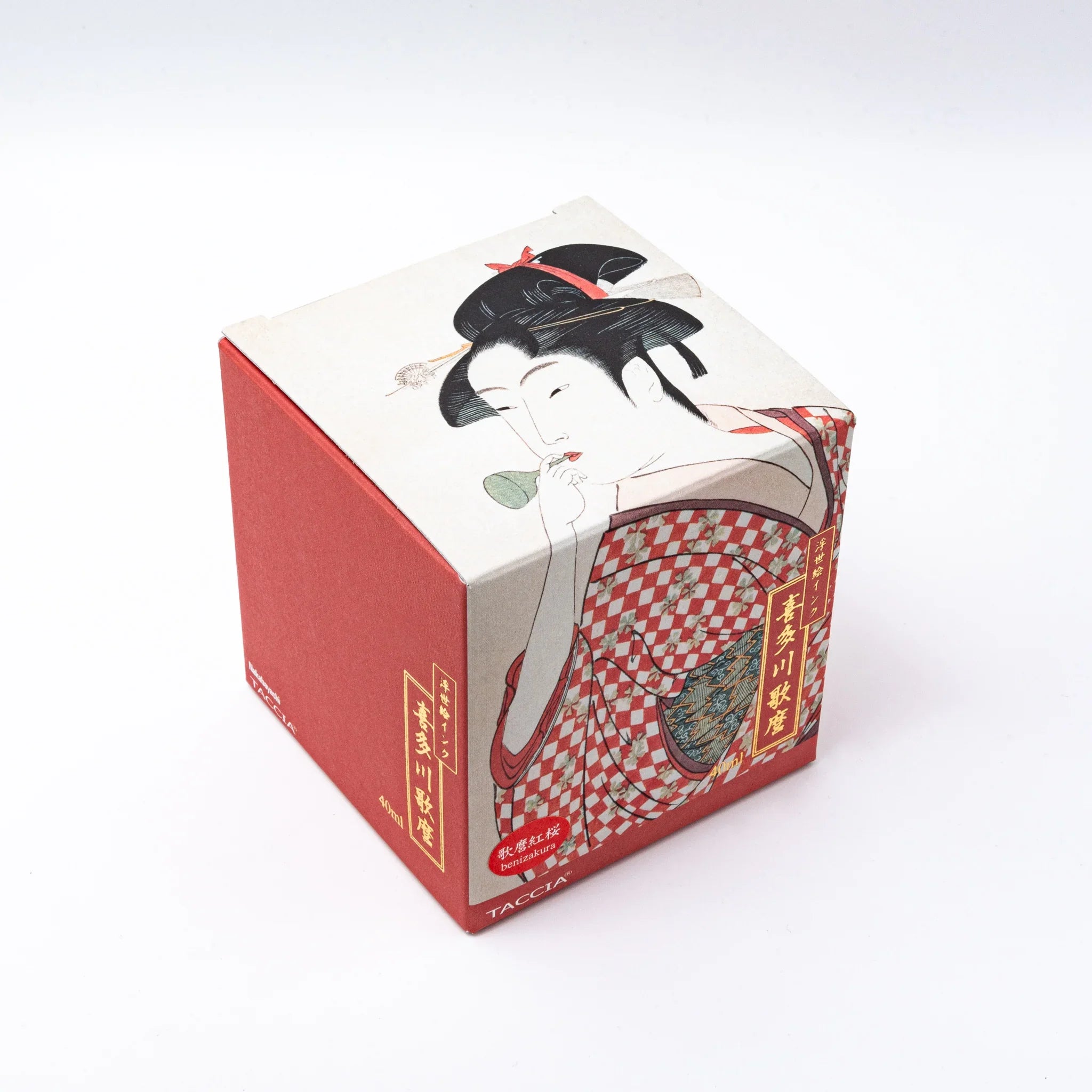TACCIA Utamaro-benizakura ink box and glass bottle set at three-quarter angle showing complete product packaging composition