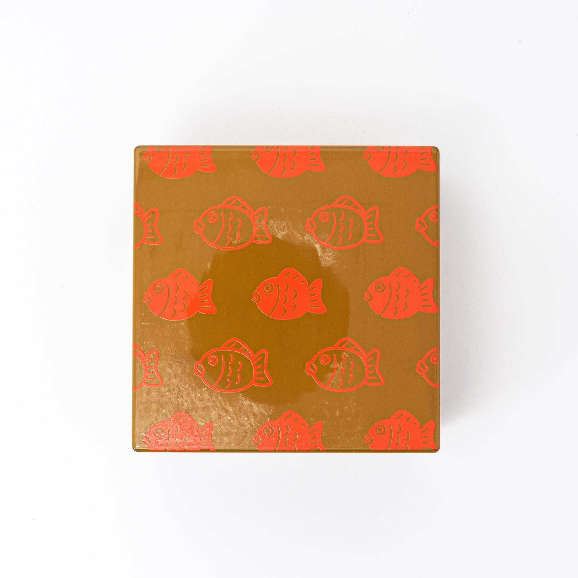 Japanese urushi lacquer trinket box closed top view with red and tan sea bream repeating pattern design
