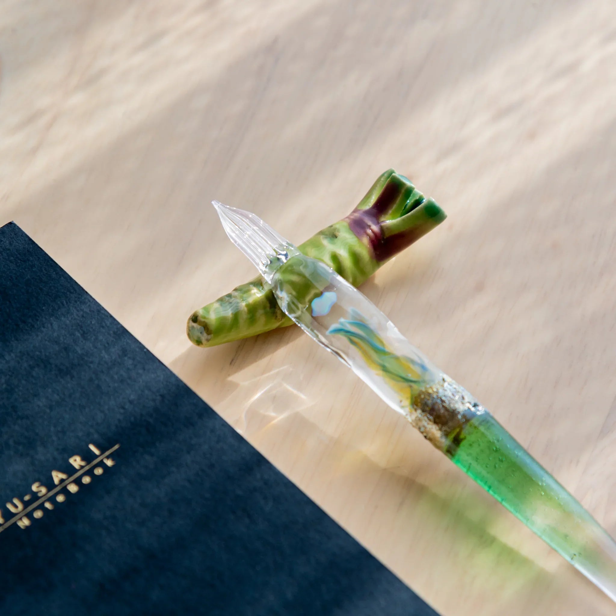 Luminous green wasabi-shaped ceramic handcrafted pen rest with roughened surface texture detail overall close shot