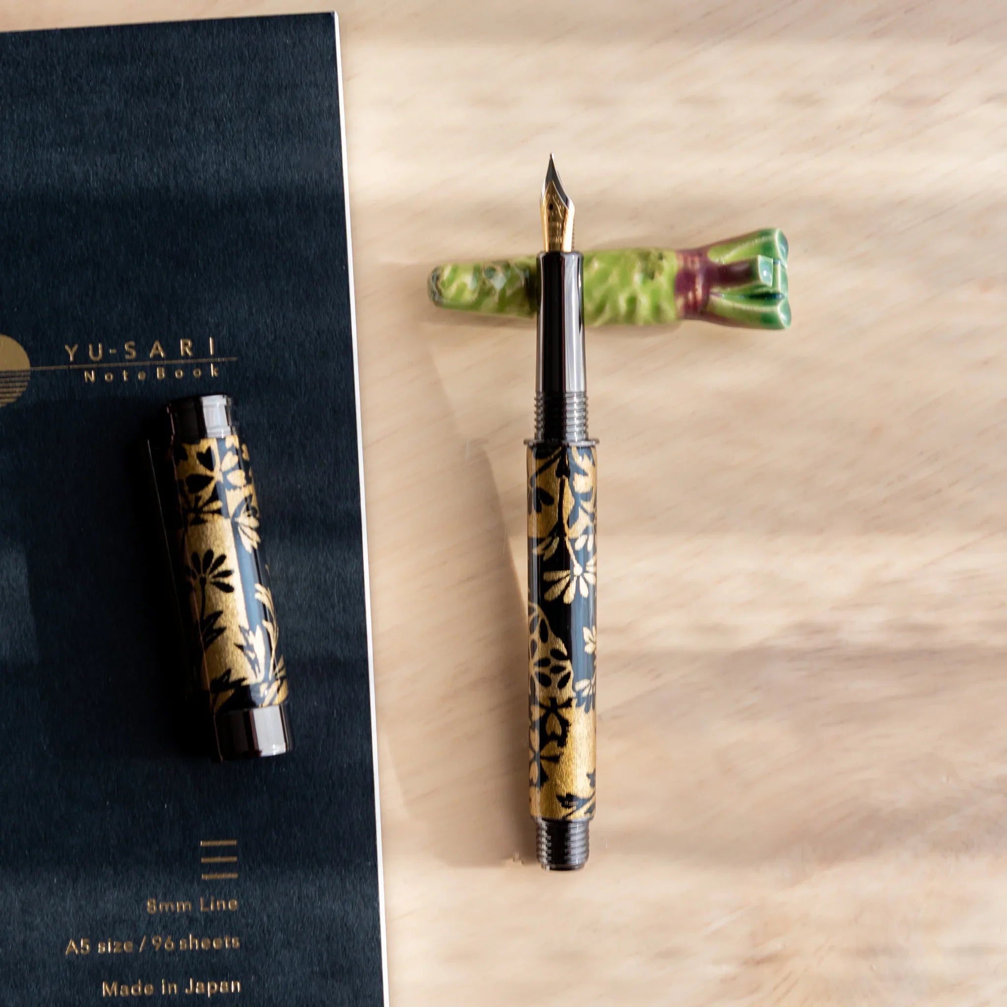 Luminous green wasabi ceramic handcrafted pen rest with bumpy textured finish throughout detailed form close shot