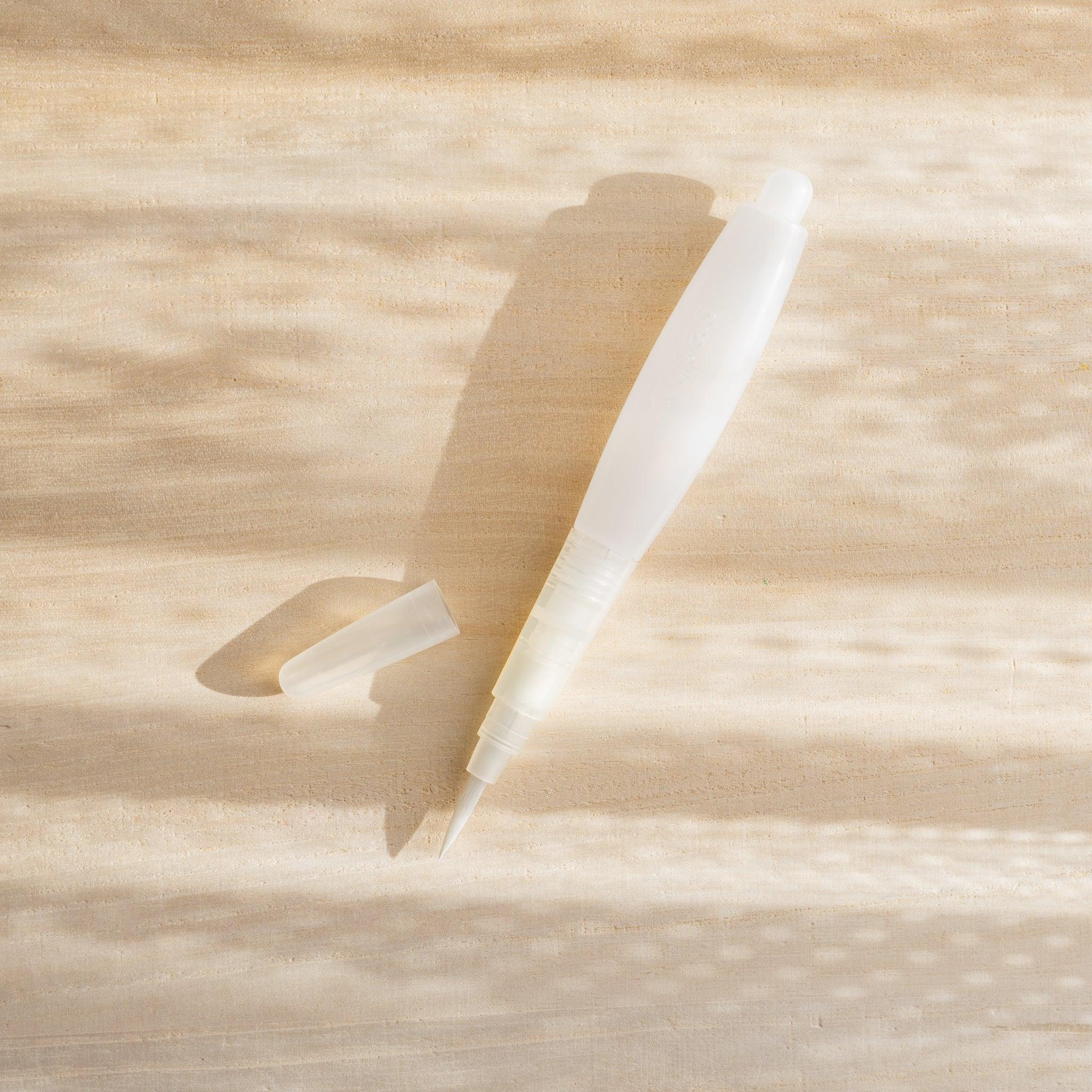 Close-up of kitpas watercolor crayons water brush pen tip, showing fine bristles and controlled water flow