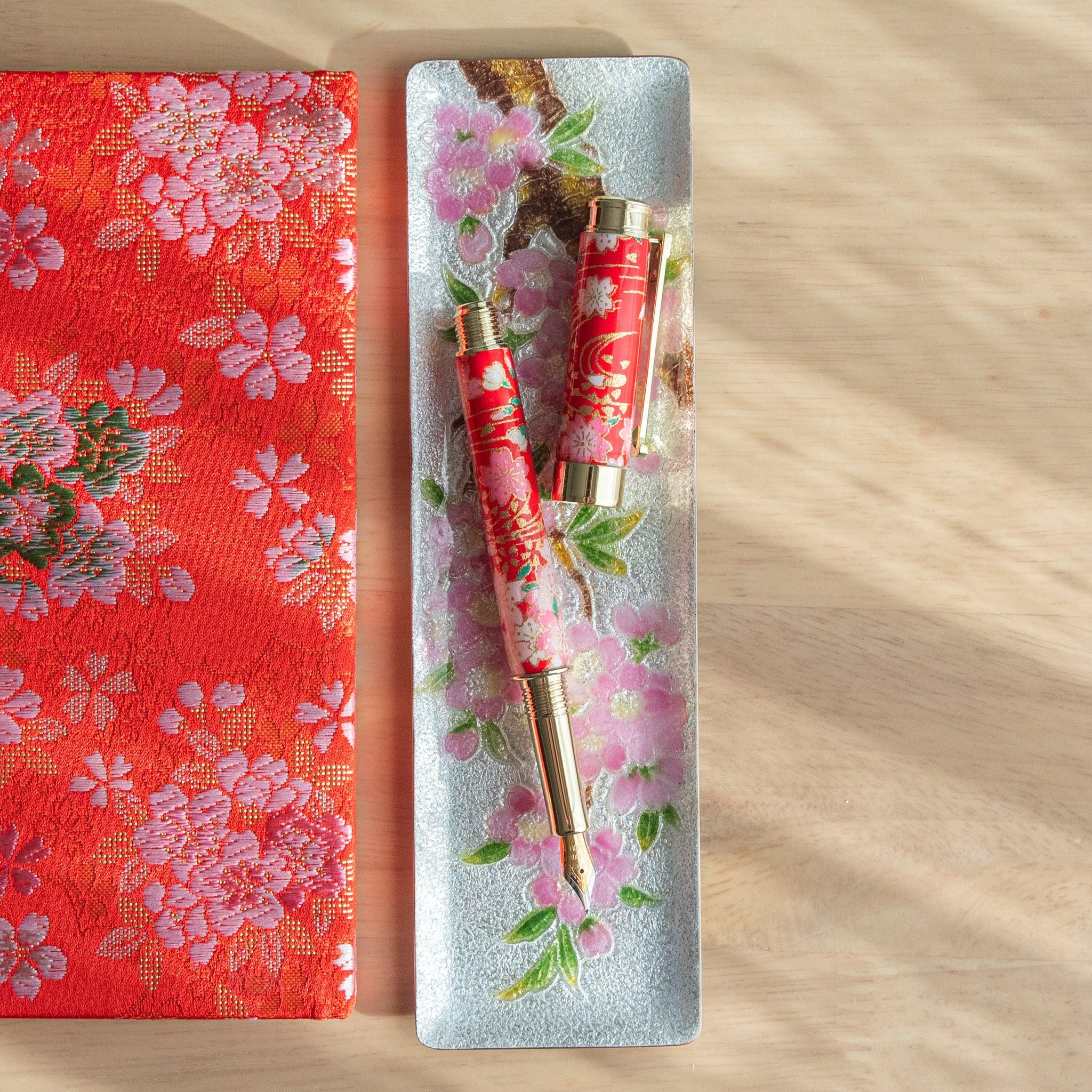 Weeping Sakura Mino Washi fountain pen barrel with white and pink sakura blossoms on red washi wrapper with nib