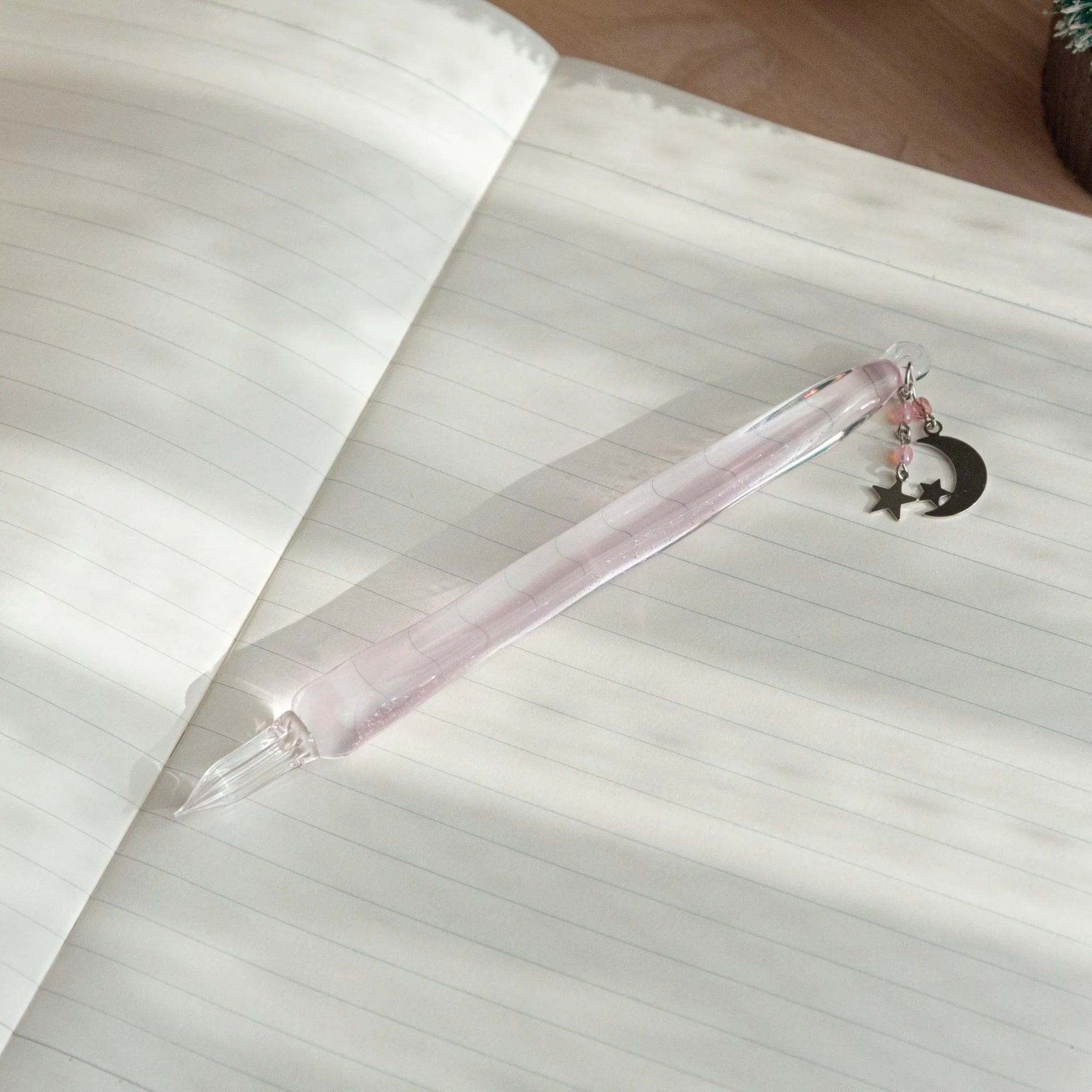 Pink hourglass-shaped glass dip pen featuring wish upon a star celestial design and stellar pattern decoration