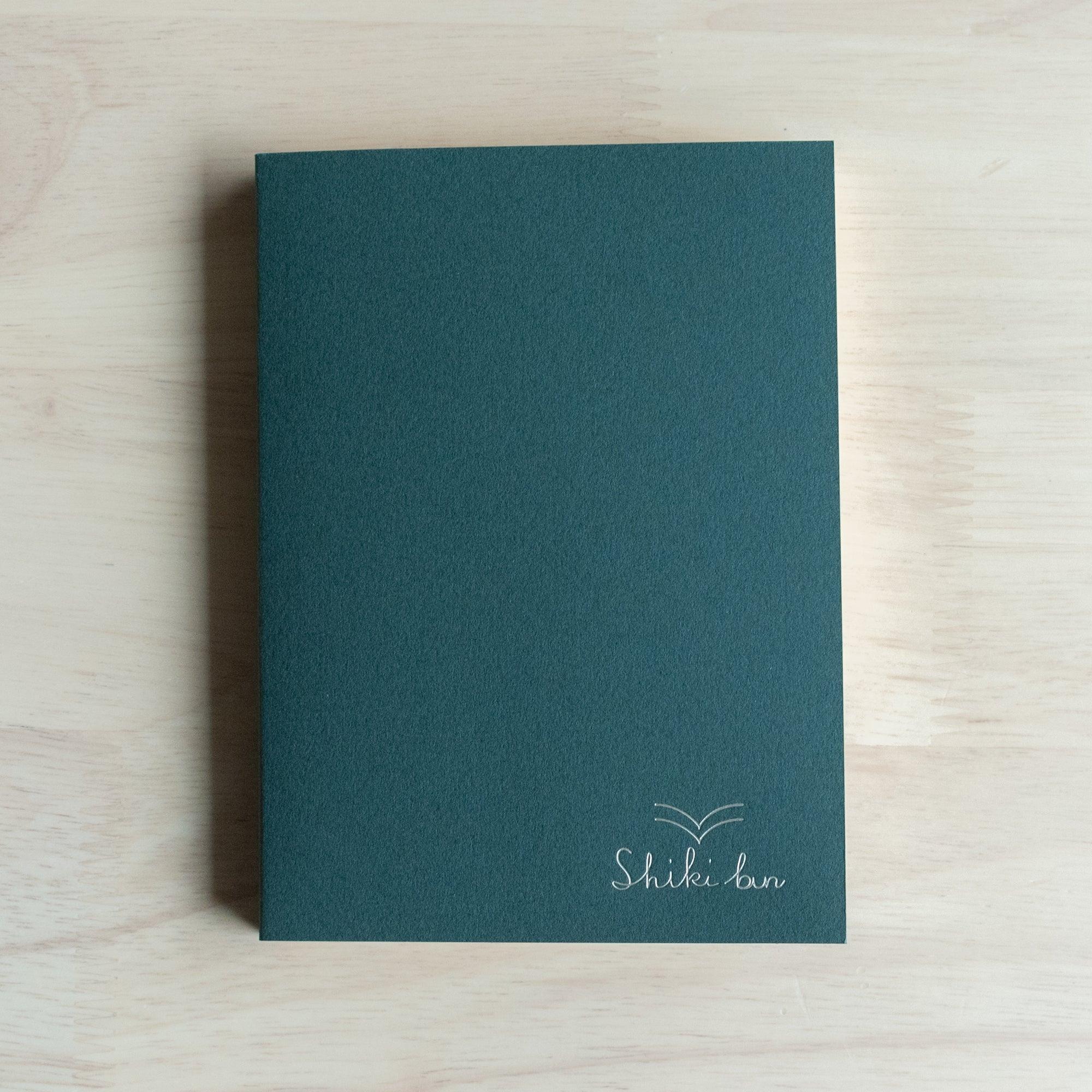 Deep green cover of Wooden Page A6 Notebook with Shiki-bun branding - 100 red pine wood pages inside