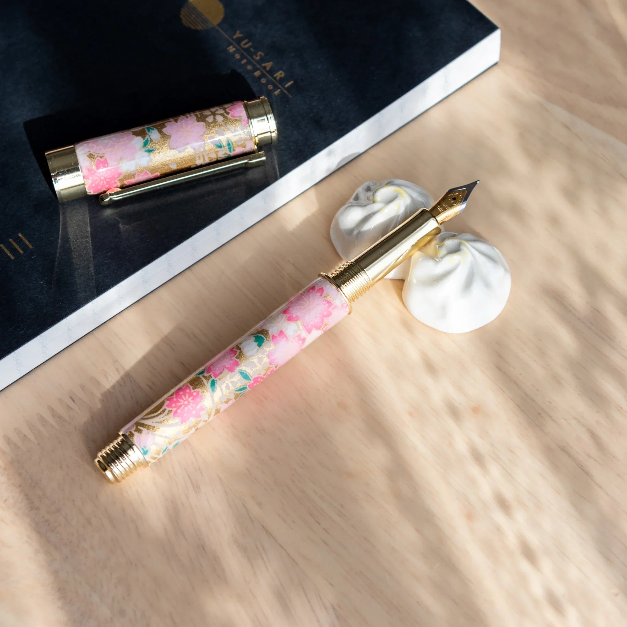 Xiaolongbao ceramic pen rest handcrafted Japanese with pleated dumpling design close-up shot