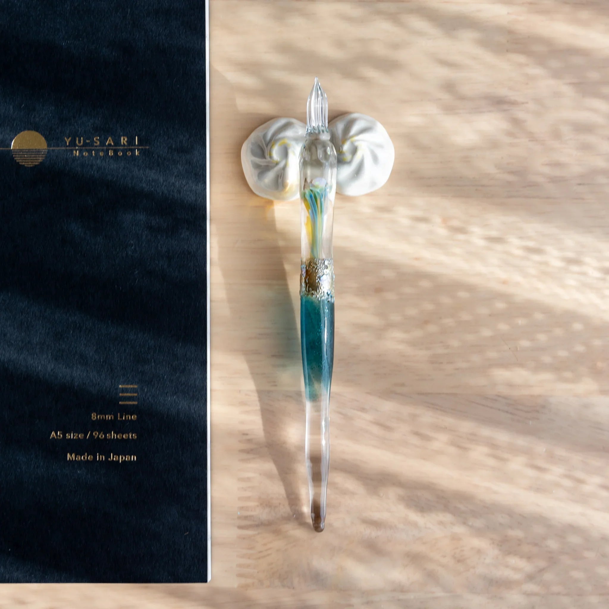 White pleated xiaolongbao ceramic pen rest with intricate handcrafted dumpling design and surface texture detail