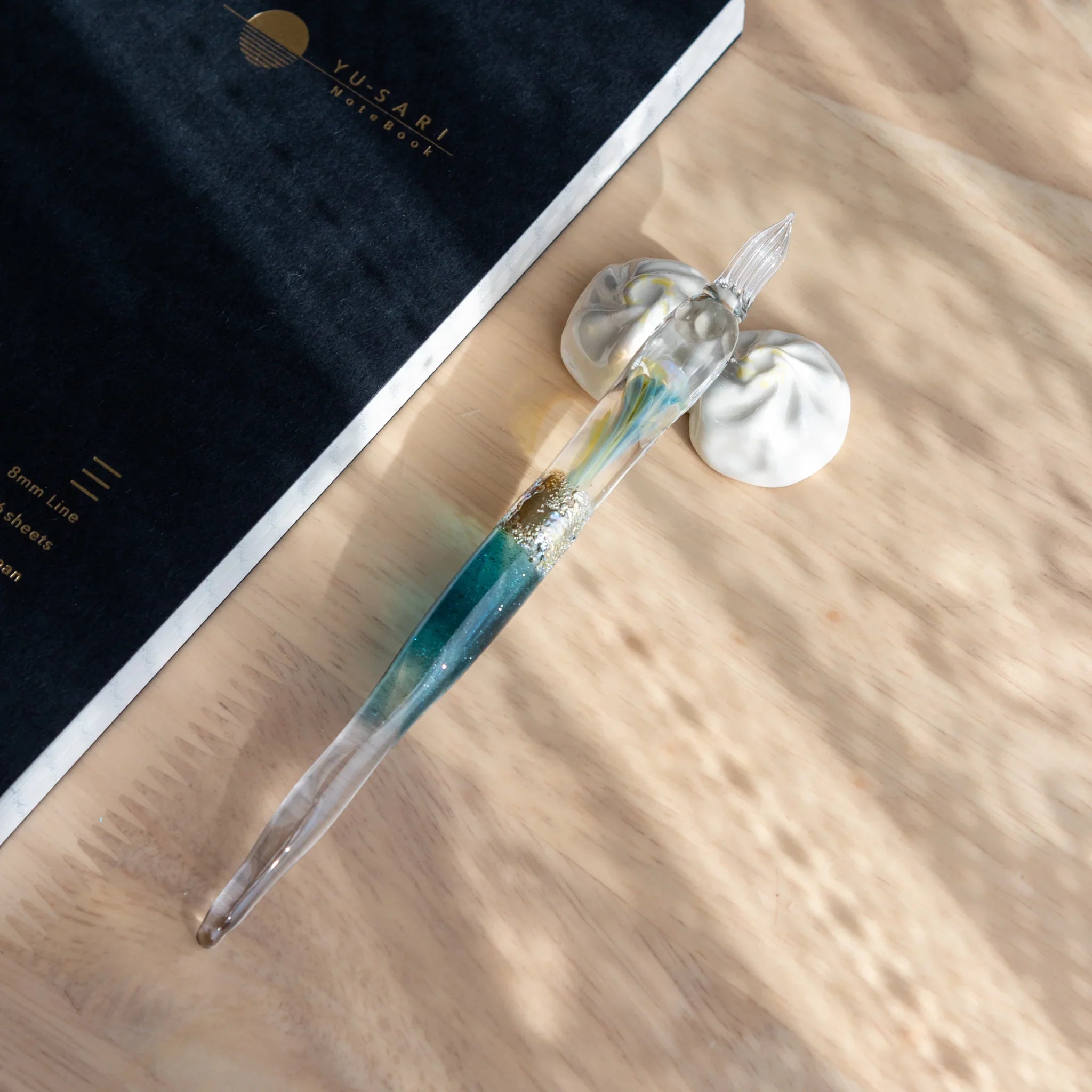 Xiaolongbao dumpling pen rest white ceramic handcrafted Japanese with realistic shape visible from above close shot