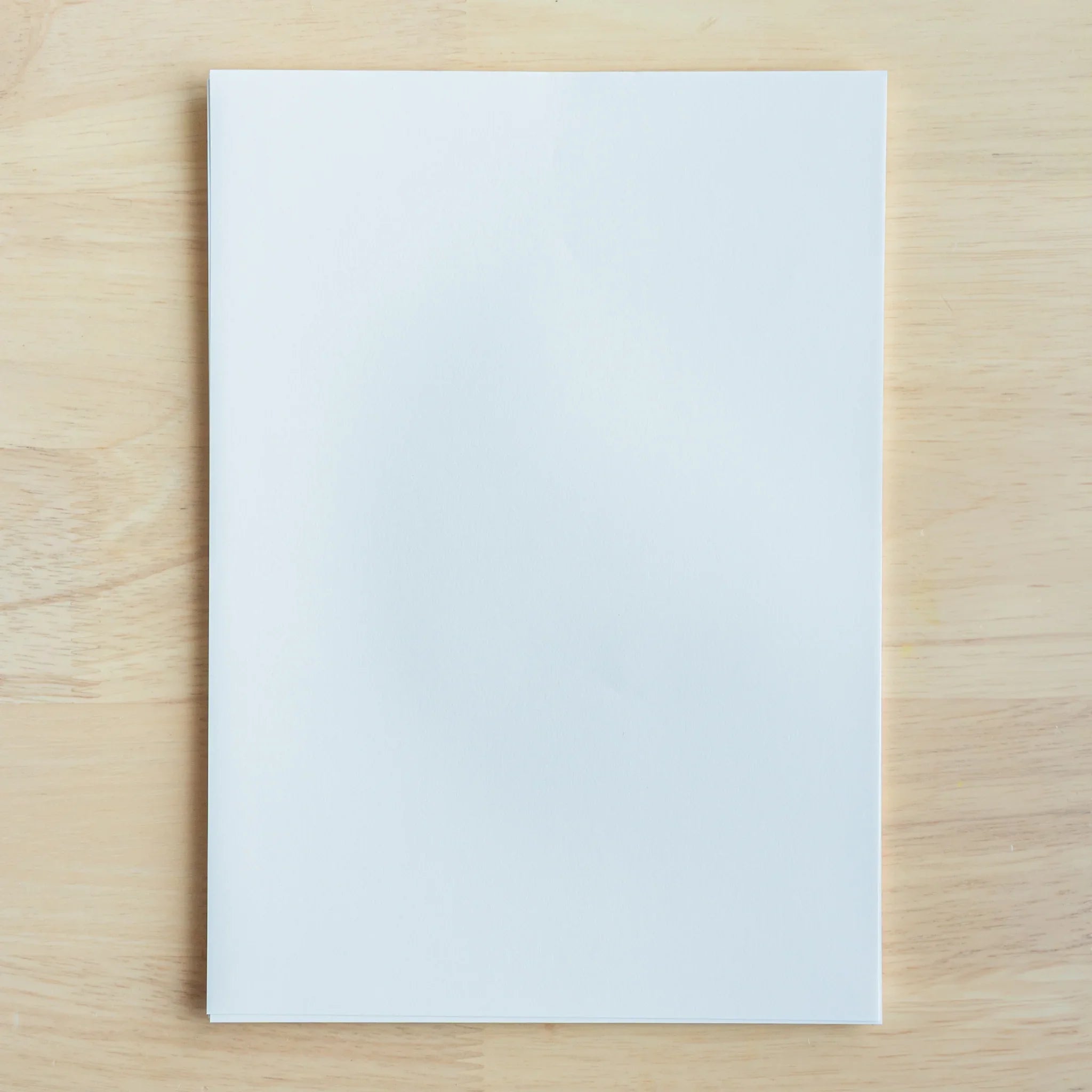 YU-SARI loose leaf paper stack viewed from side angle highlighting sheet quality and bound edge construction detail