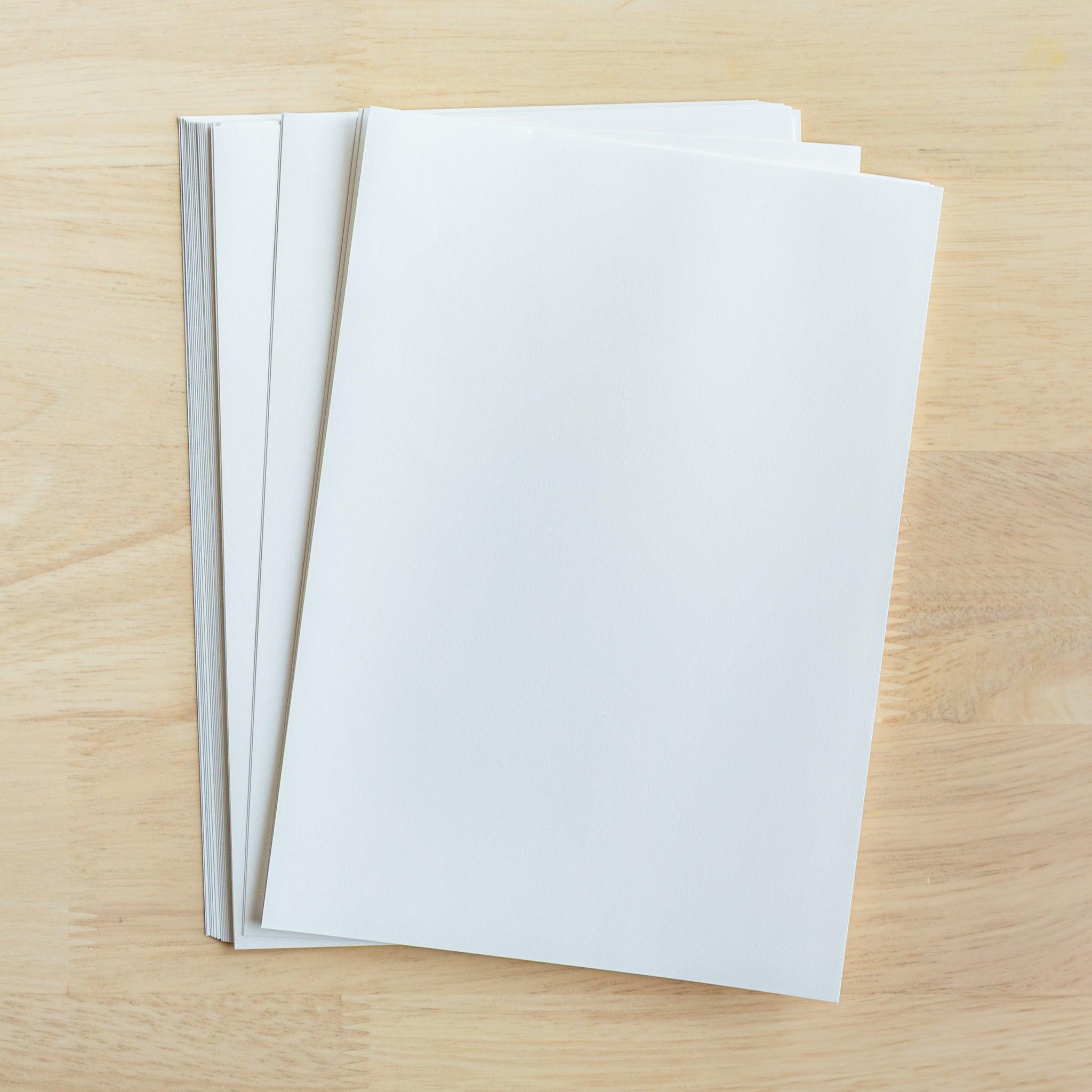 Many sheets of YU-SARI loose-leaf paper stacked on top of each other. Japanese stationery with white paper for fountain pens.