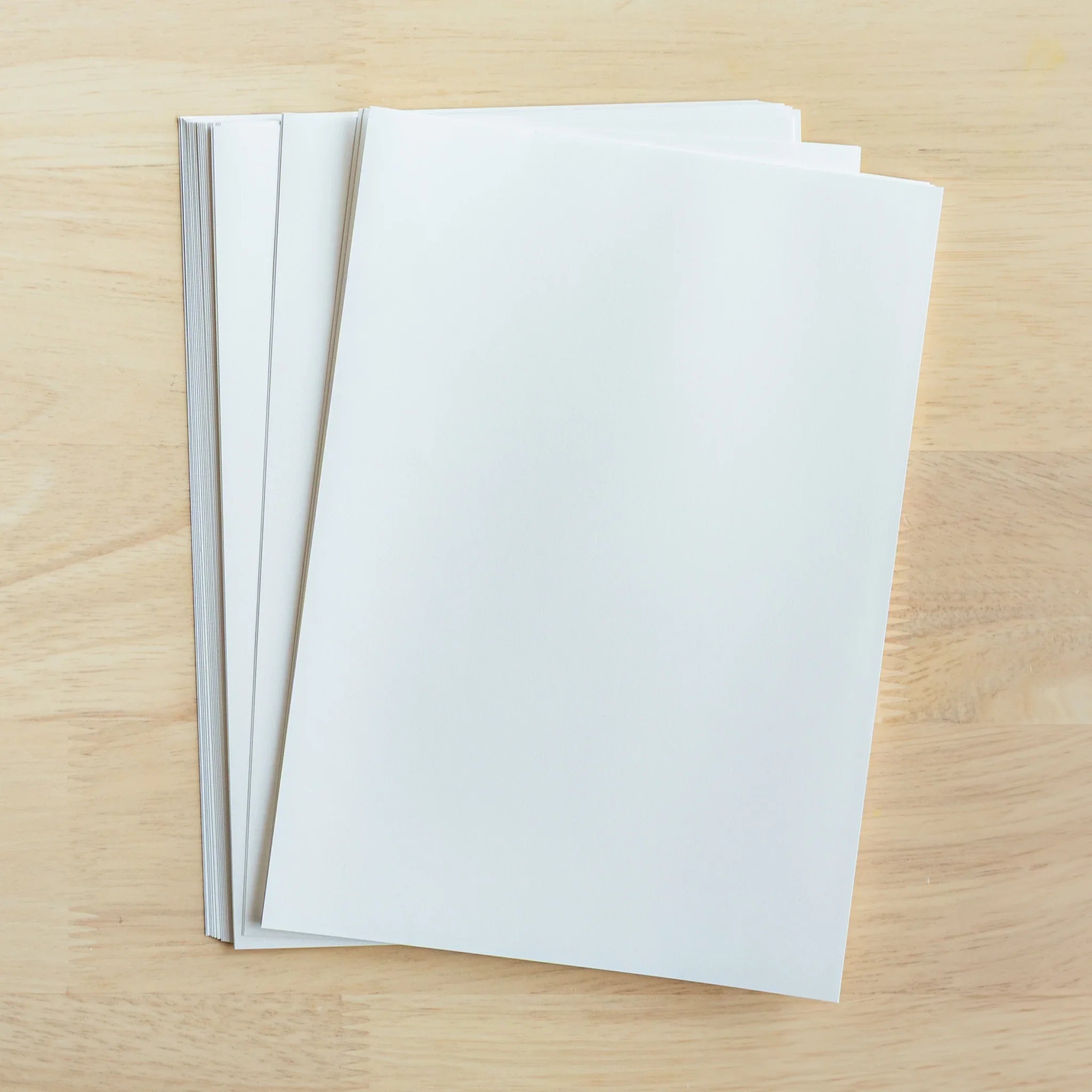 YU-SARI loose leaf paper multiple packages flat lay wooden background showing different size options packaged format