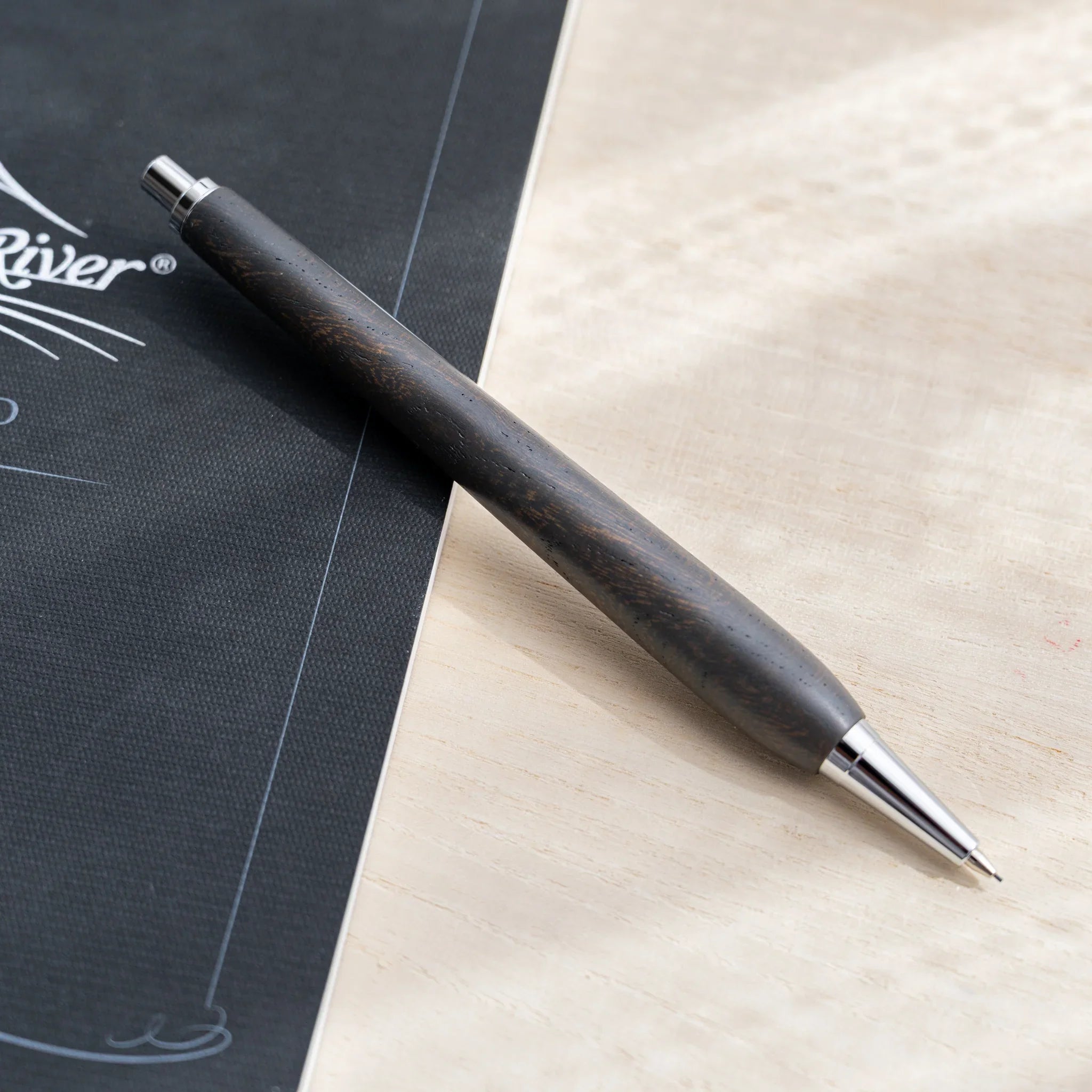Charcoal black zelkova wood urushi mechanical pencil, close-up of barrel wood grain, Japanese keyaki wood