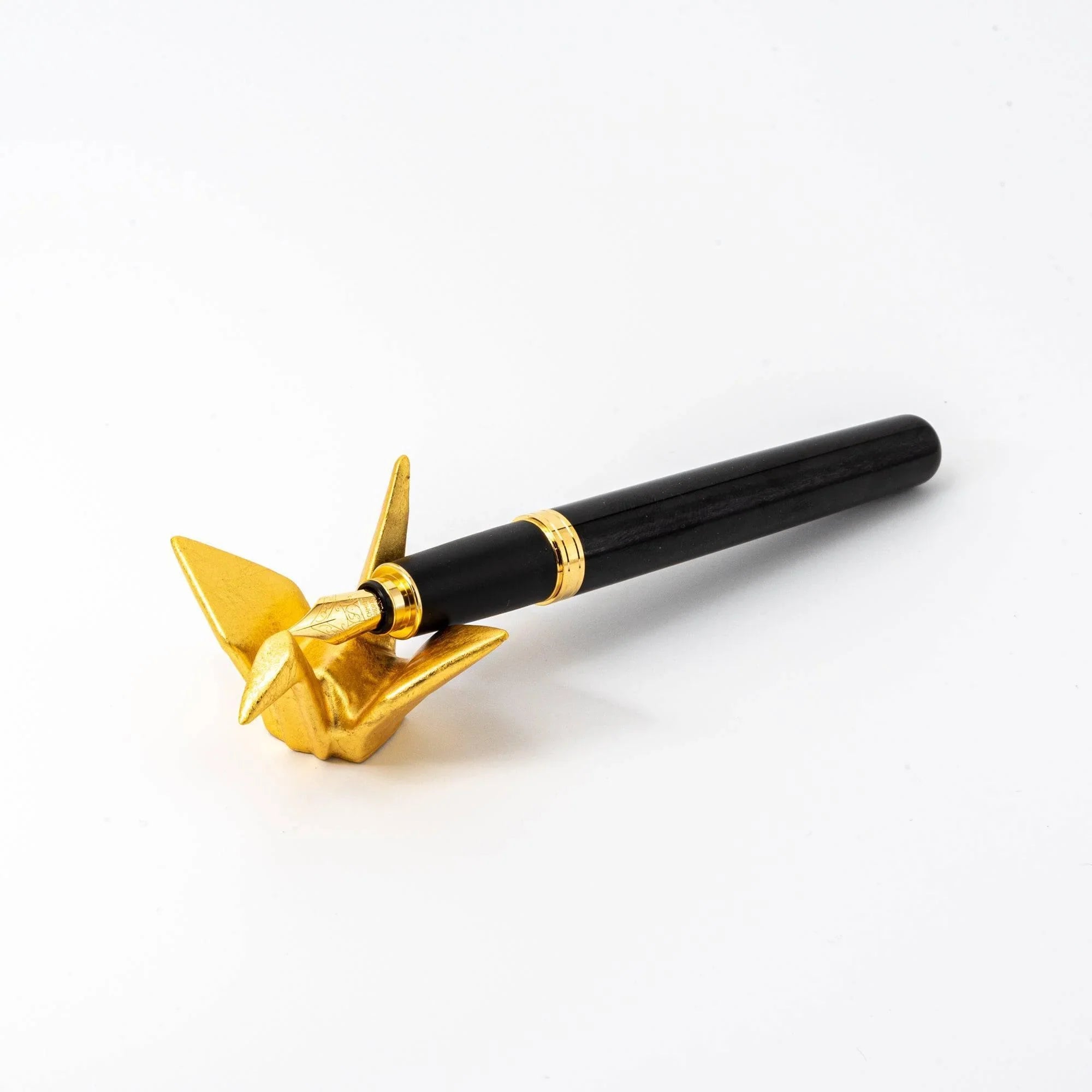 Pair of Japanese gold ceramic crane pen rests positioned together showing both pieces white background