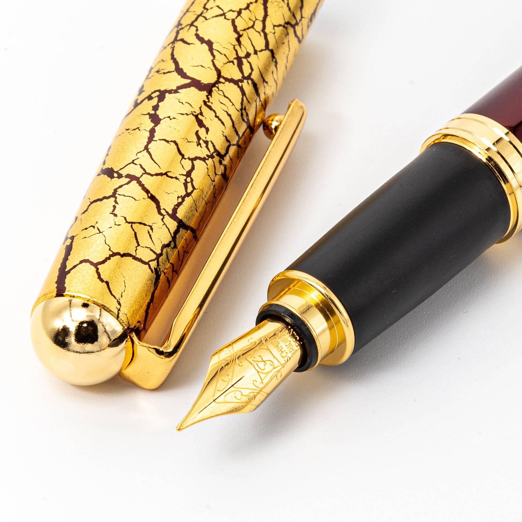Wine red fountain pen body view with prominent gold leaf crackle texture detail on deep red lacquer finish