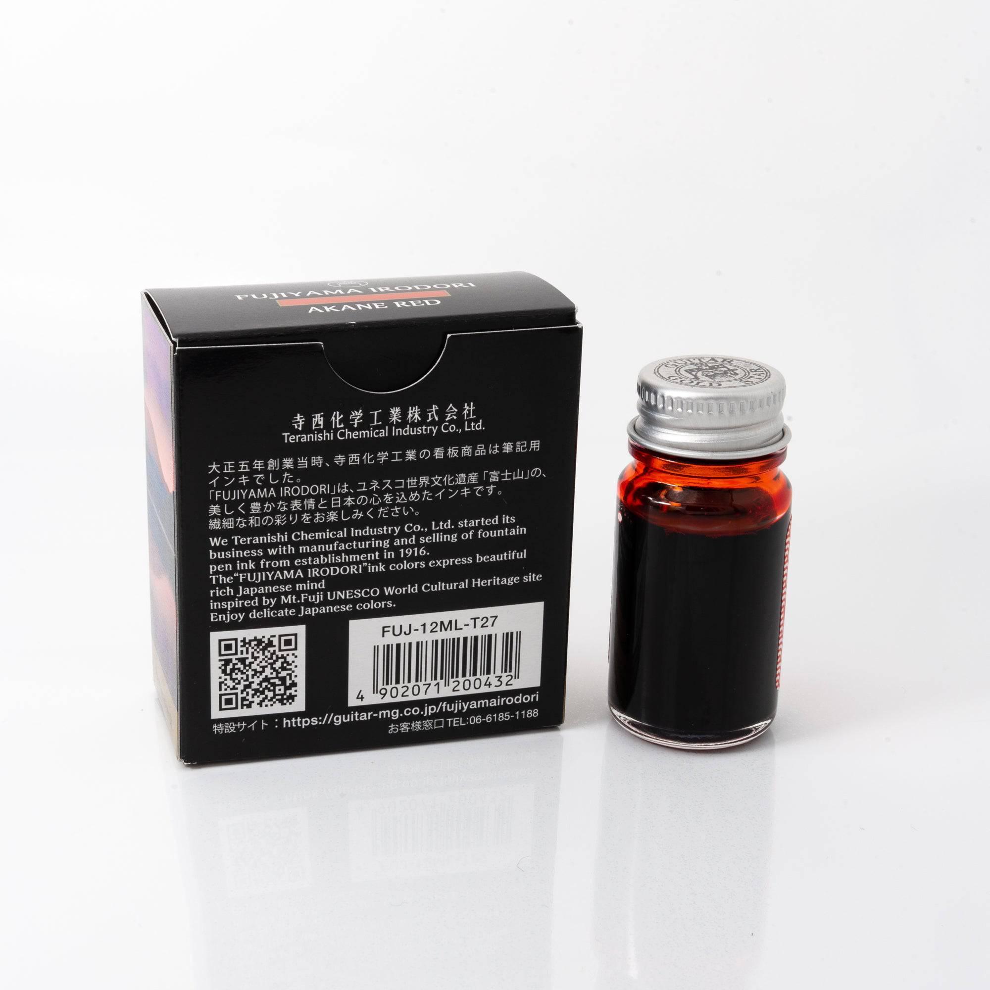 Fujiyama Irodori Akane fountain pen ink bottle and matching pen, arranged on a wooden desk, emphasizing coordinated design.