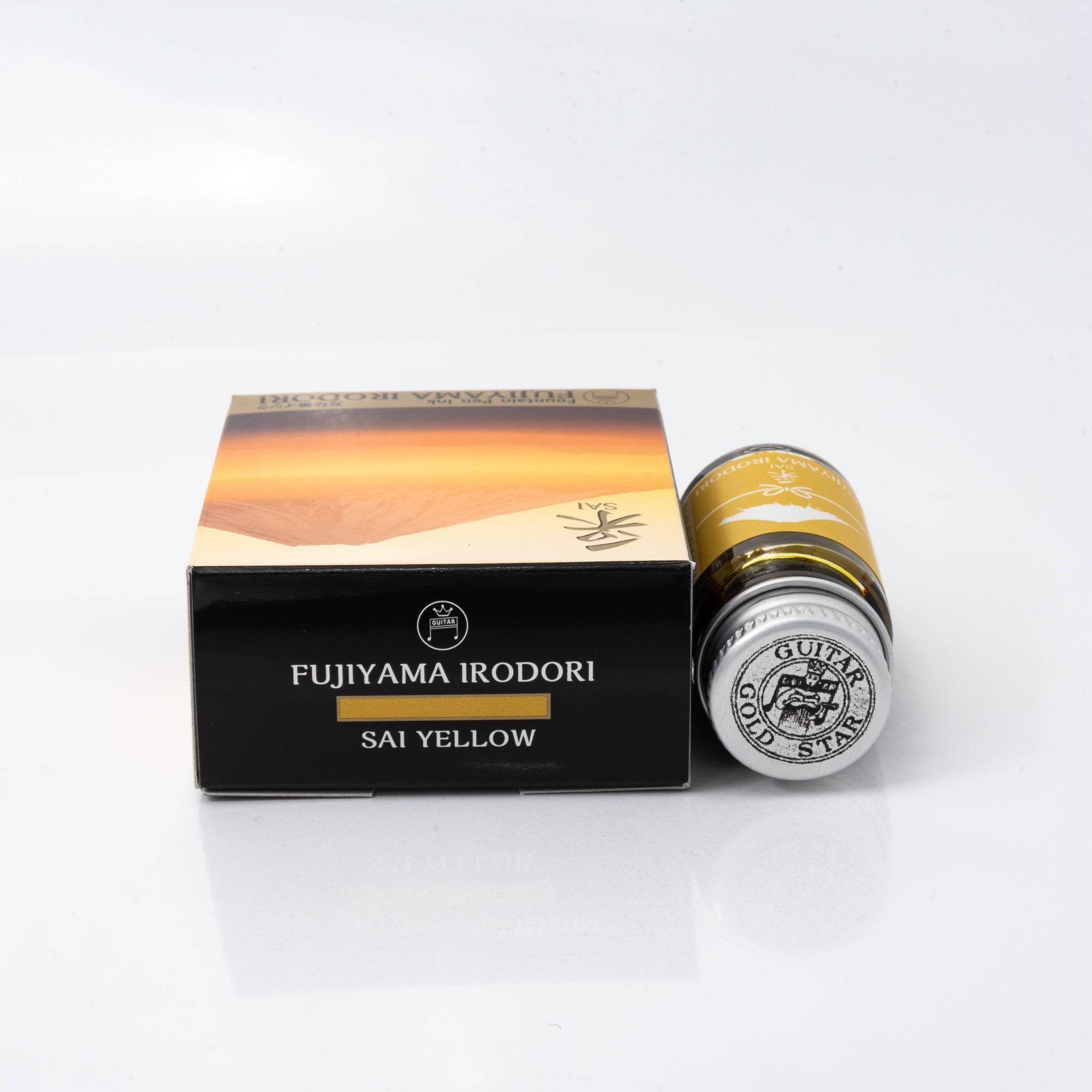 Top view of the Fujiyama Irodori Sai ink bottle, showcasing its vibrant yellow ink, surrounded by natural wooden textures.