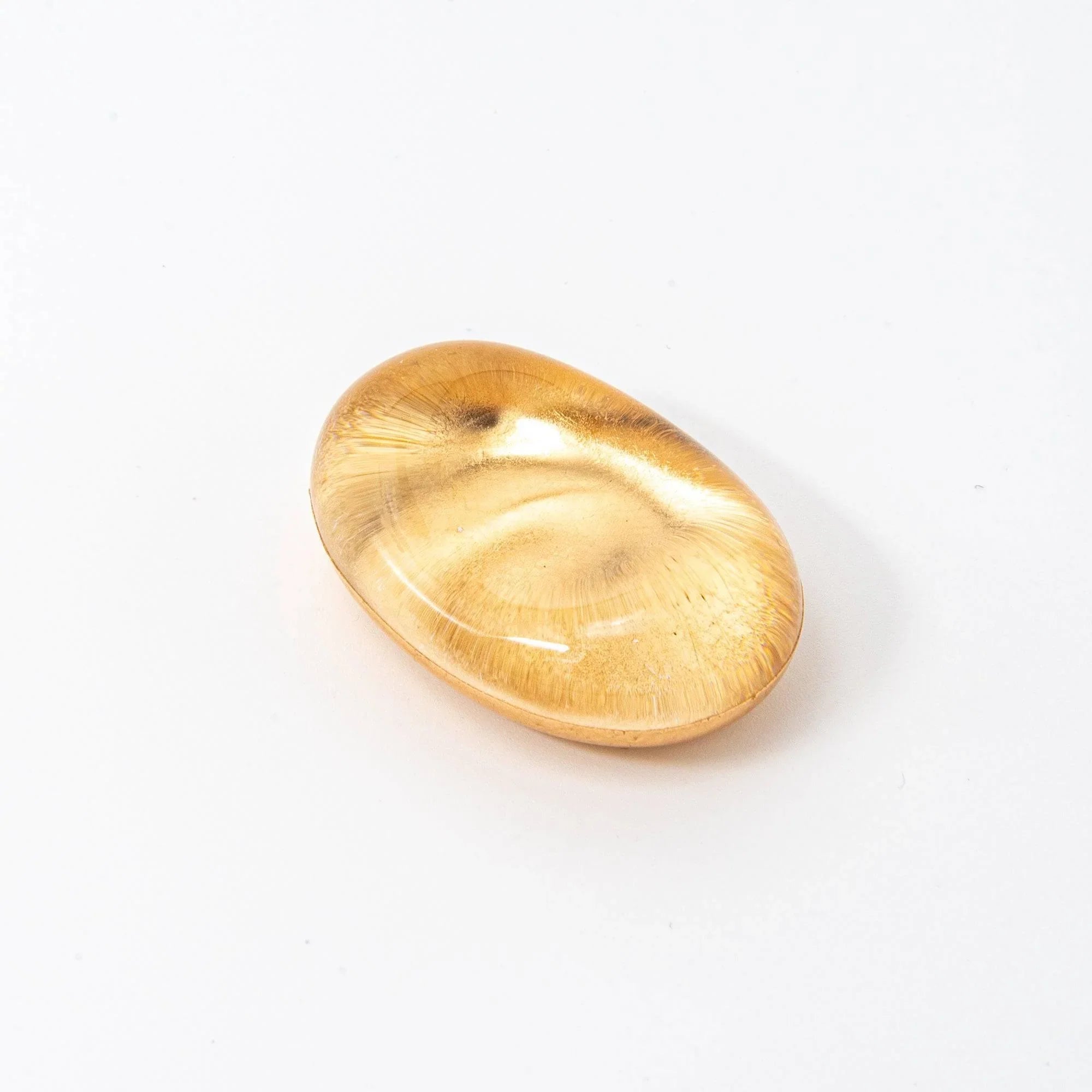 Japanese amber glass pen rest with iridescent floating gold leaf design visible throughout interior, angled product view