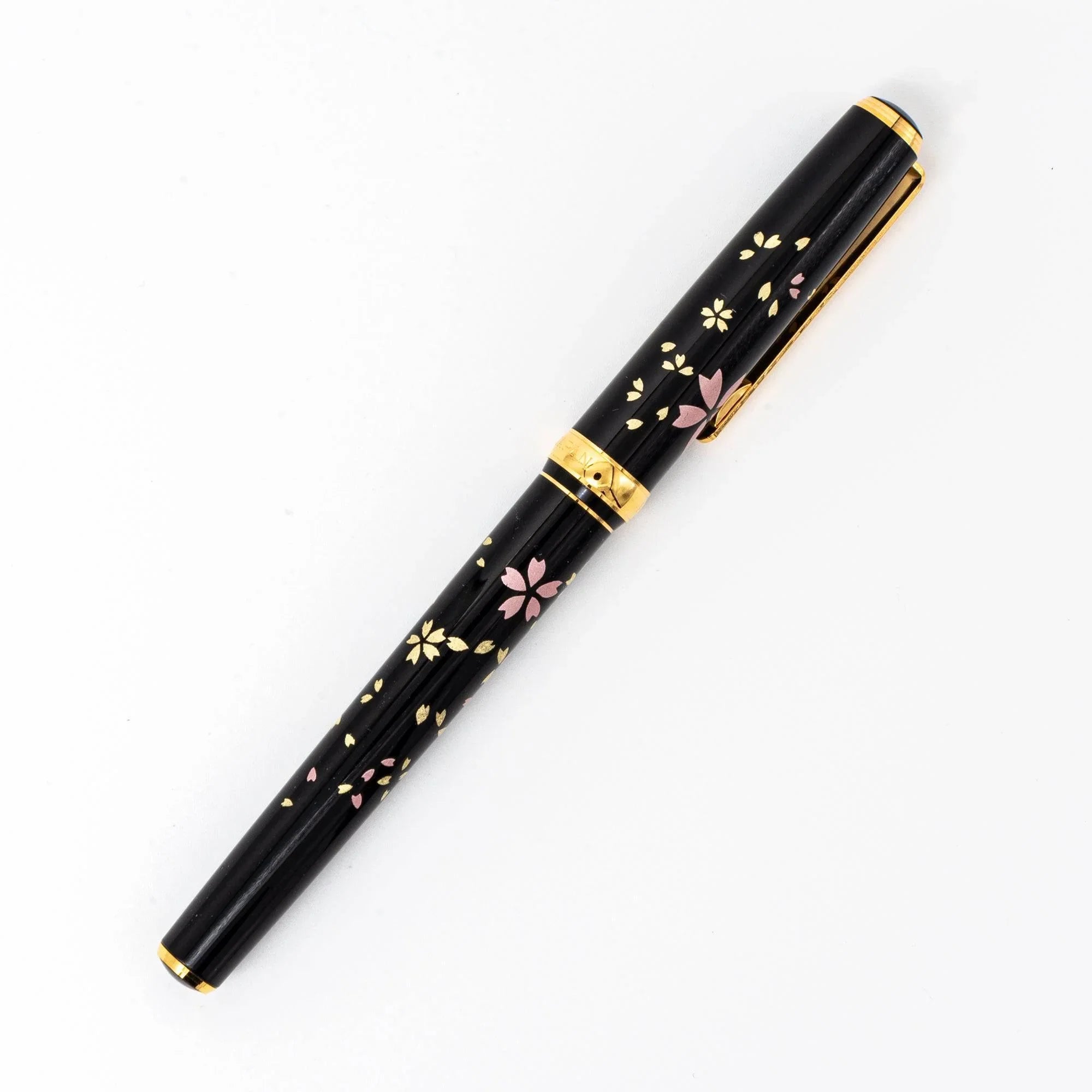 Gold fountain nib detail showing intricate sakura Makie cherry blossom design, Japanese craftsmanship
