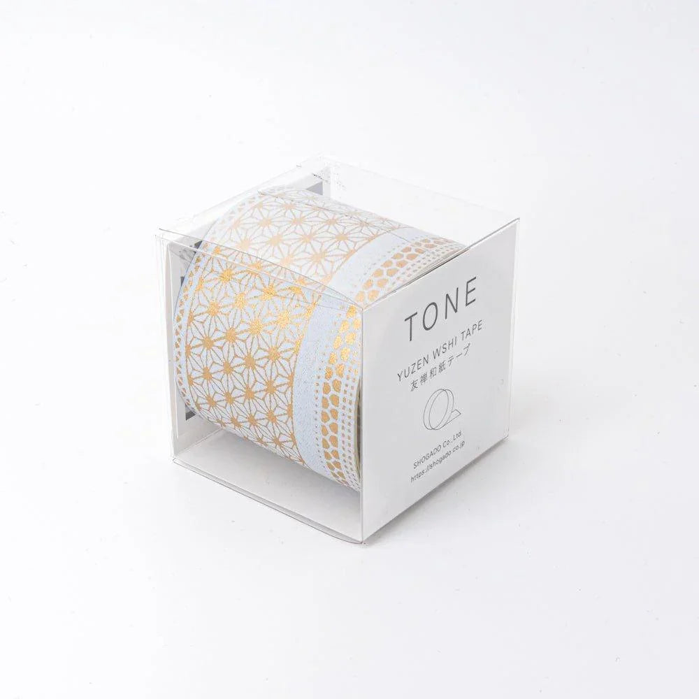 Japanese hand-dyed yuzen washi tape in clear acrylic TONE box, gold asanoha and kikko geometric patterns on pale grey ground