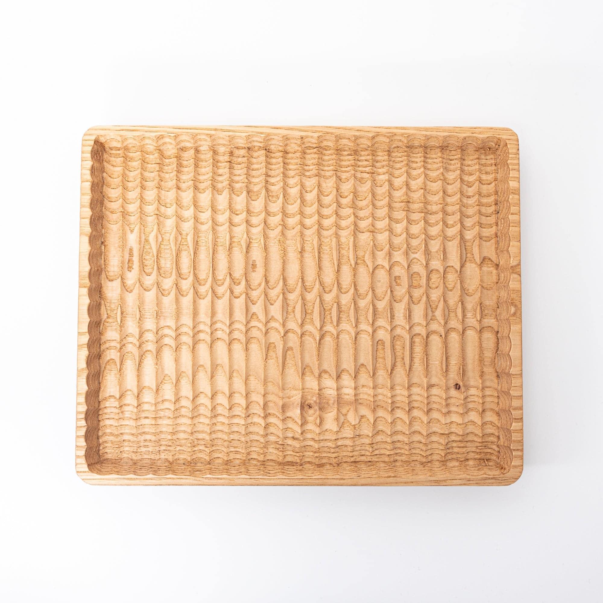 A plain wooden tray with detailed grooves, shown against a white background.