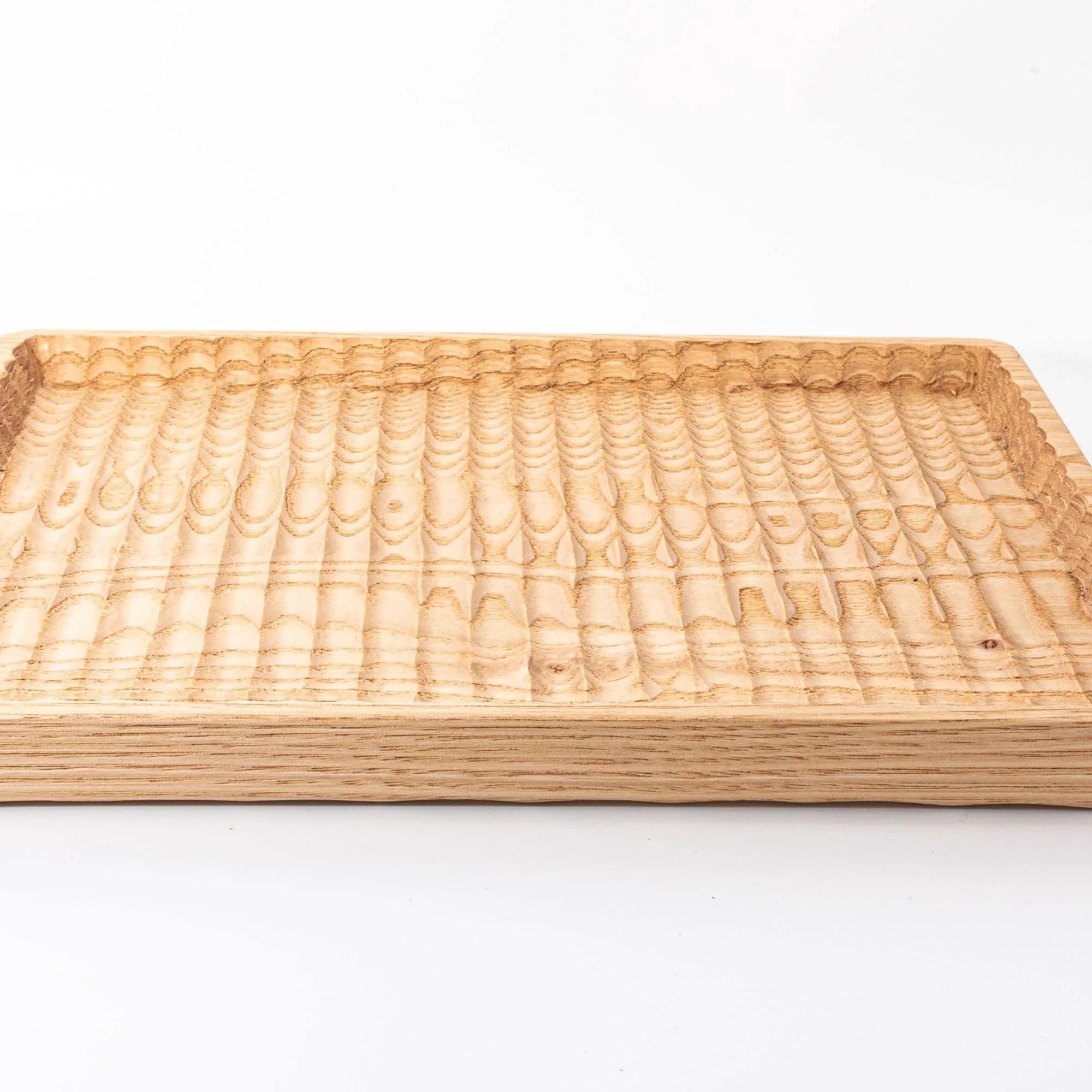 Japanese hand-carved chestnut wood pen tray close-up showing curved carved edges and smooth finished surface detail