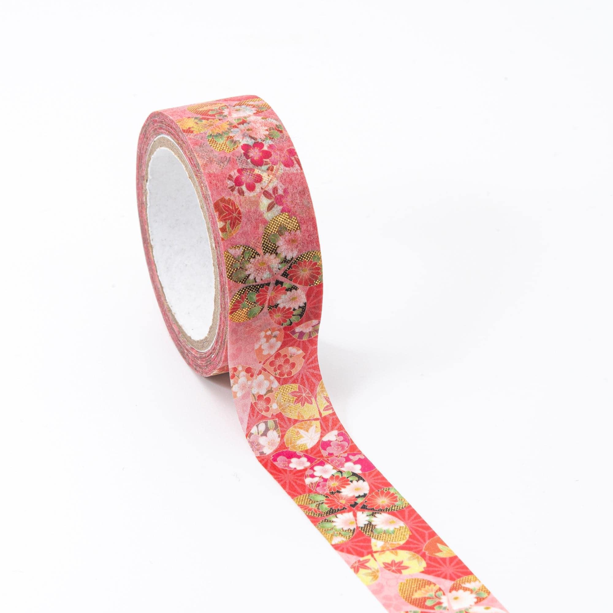Close-up of Japanese stationery washi tape highlighting intricate floral patterns, sakura details, and gold embellishments on a vivid background.