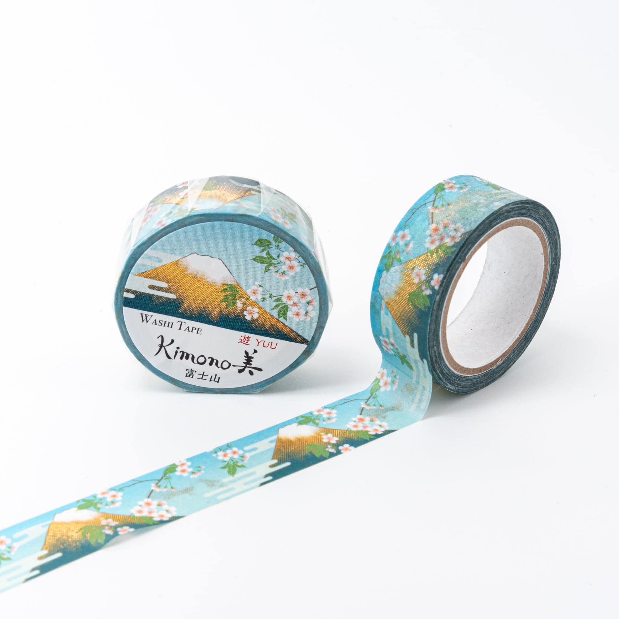 Roll of Iyo Washi Tape with Mt. Fuji patterns, unraveling to reveal its artistic motifs, placed on a wooden desk under soft lighting.