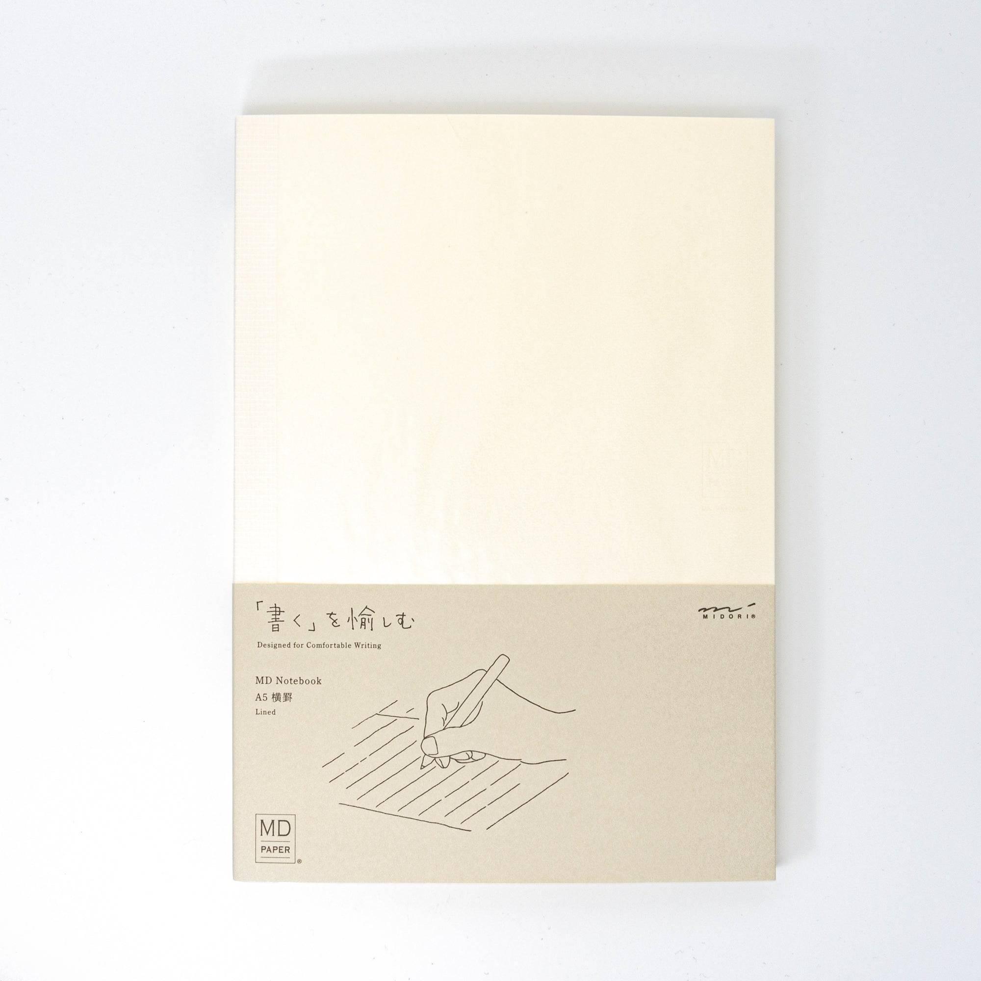 A Japanese stationery MD Notebook with a beige cover, designed for comfortable writing. The minimal design features a hand-drawn illustration and text.