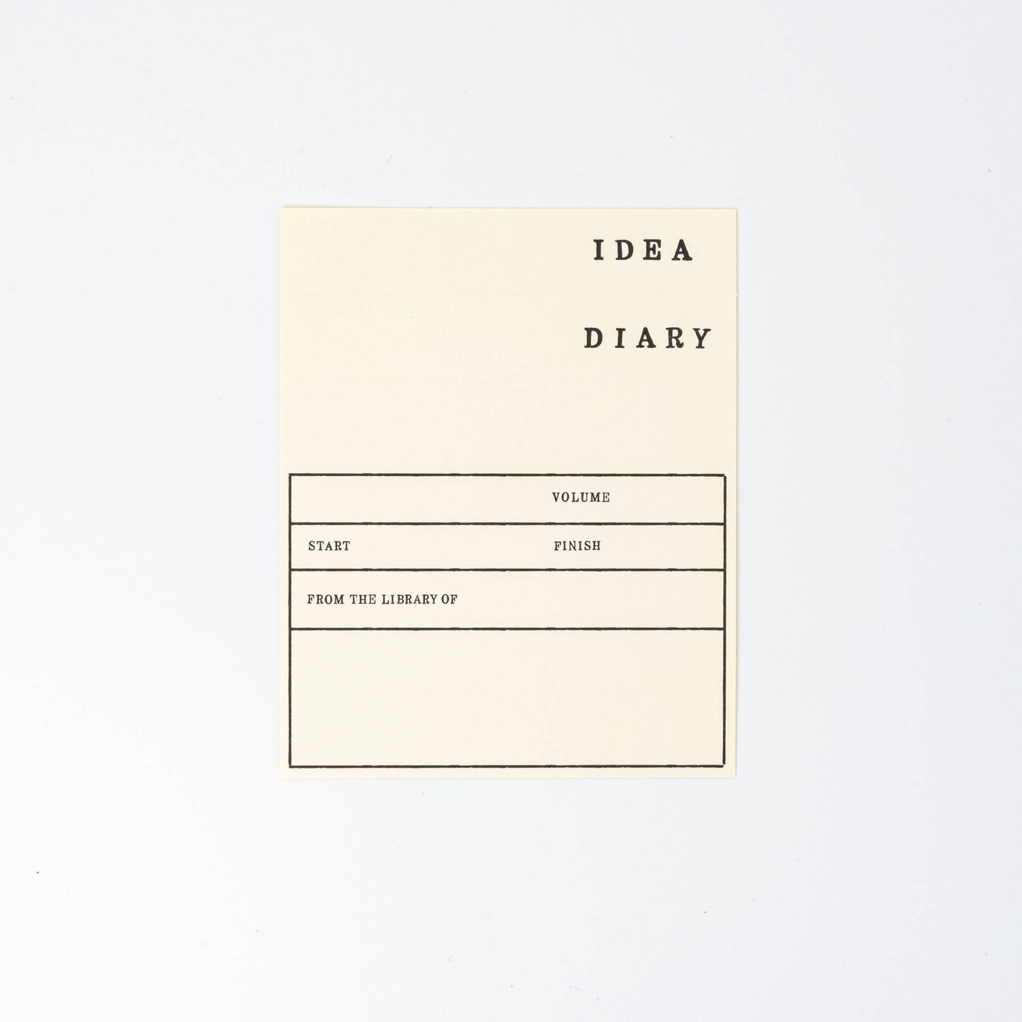 A Japanese stationery MD Notebook accessory, the "IDEA DIARY" label, features customizable sections for volume, start, finish, and ownership details.