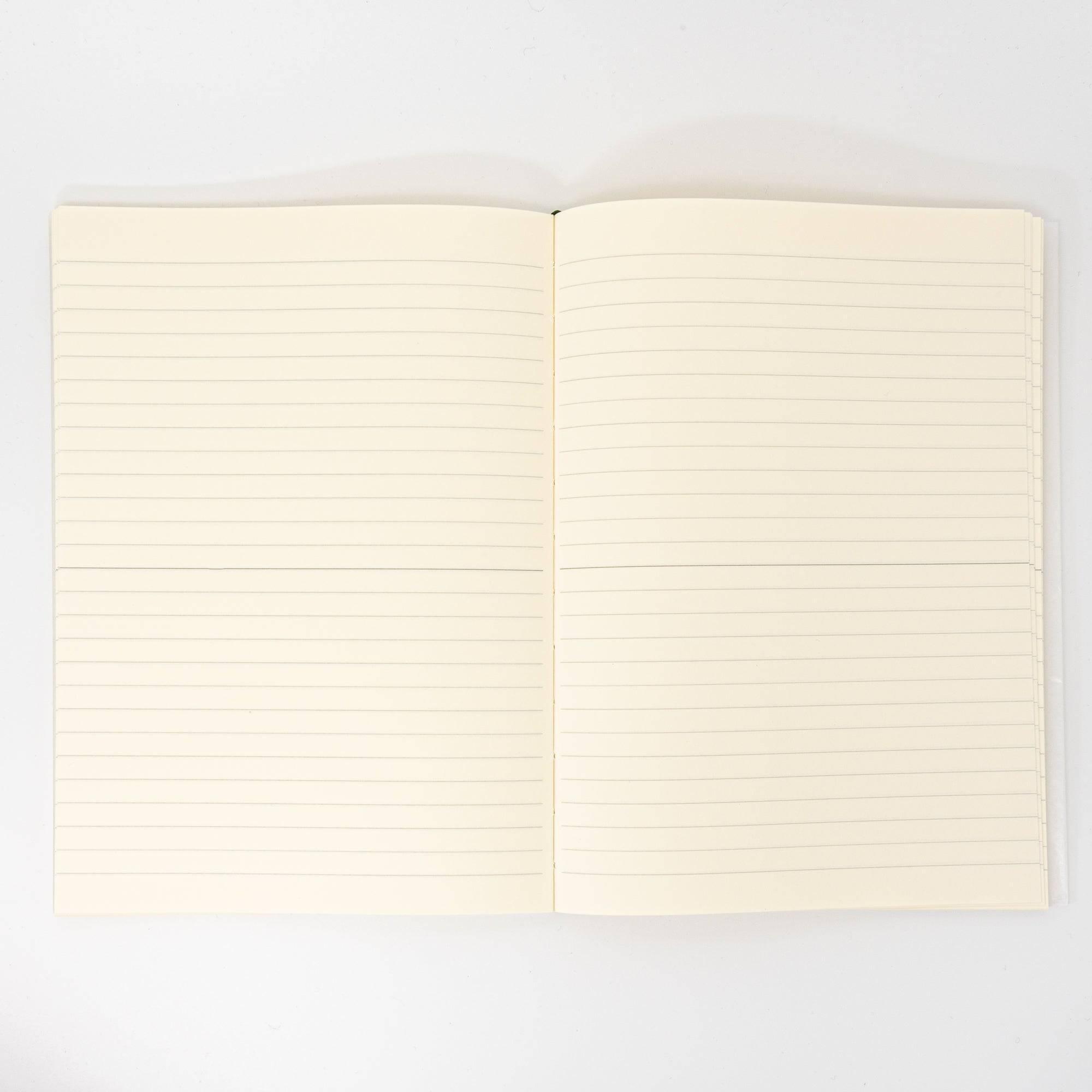An open Japanese stationery MD Notebook with lined pages, showcasing its smooth, cream-colored paper ideal for writing with various pens or pencils.
