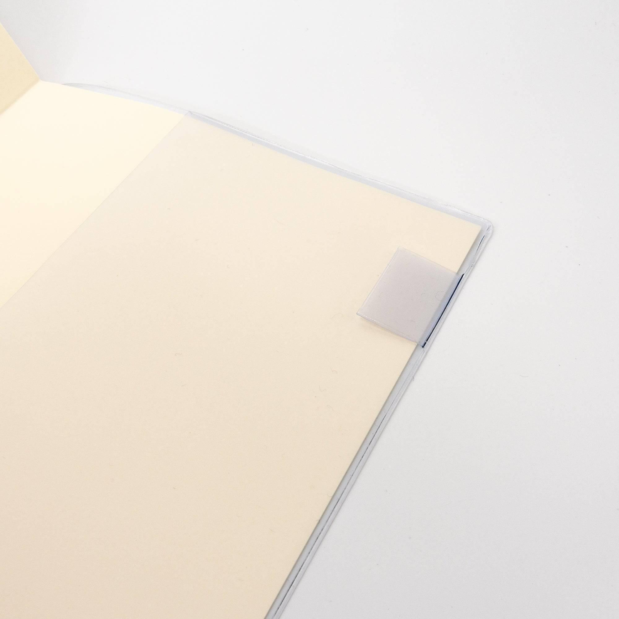 Close-up of an MD notebook’s interior corner with a transparent cover, highlighting its simple design as Japanese stationery.