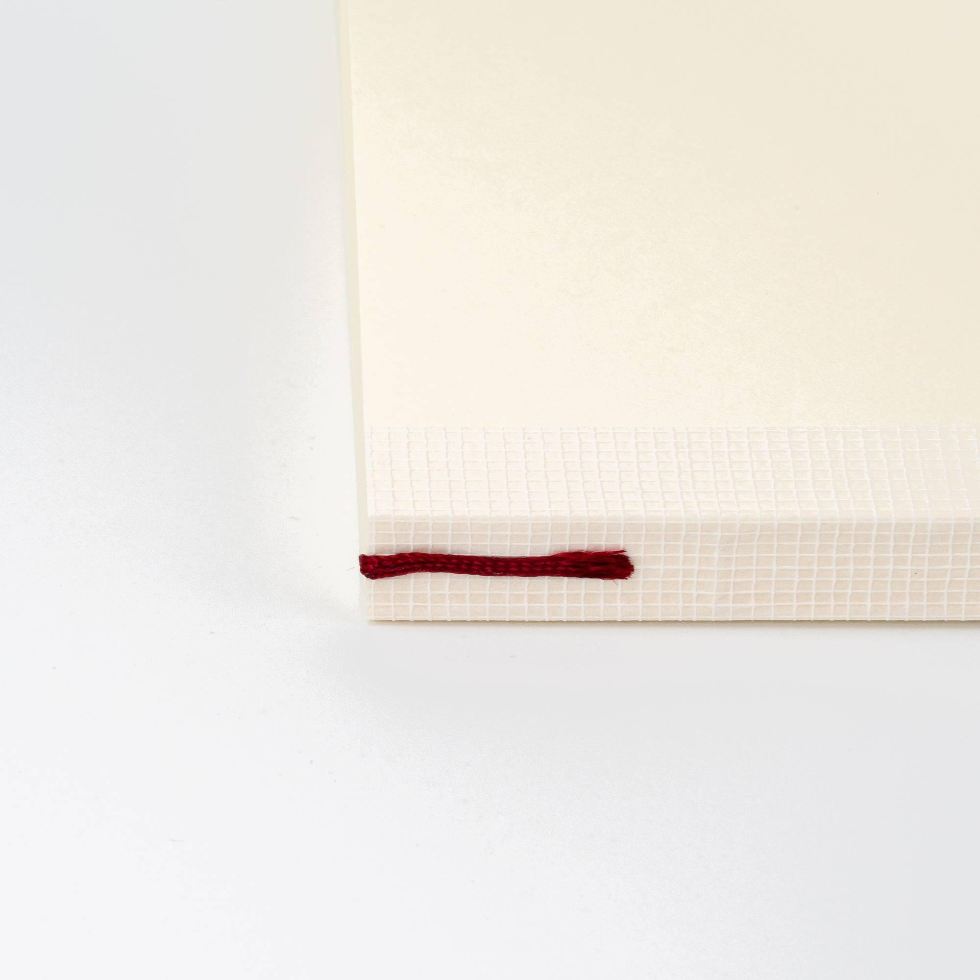 Red bookmark on the spine of an MD notebook journal, a functional and elegant Japanese stationery feature.