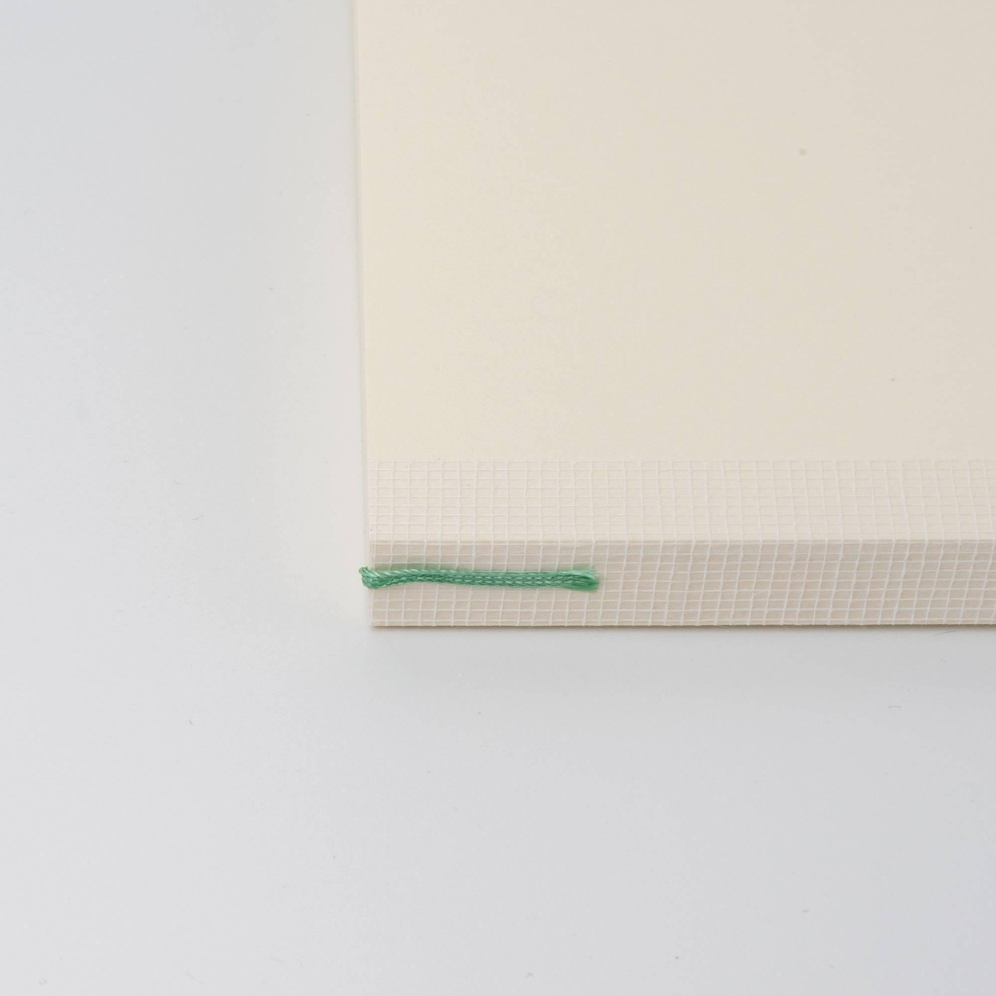 Red bookmark on the spine of an MD notebook journal, a functional and elegant Japanese stationery feature.