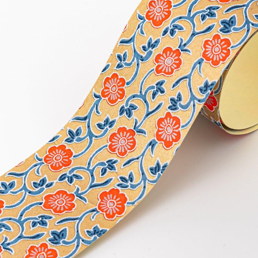Hand-dyed Yuzen washi tape featuring vibrant orange flowers and blue vine patterns on a golden background, showcasing elegant Japanese stationery design.