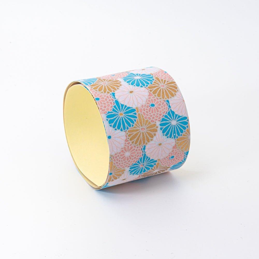 Hand-dyed Yuzen washi tape featuring intricate patterns of blue, pink, and gold flowers, showcasing the elegance of Japanese stationery.