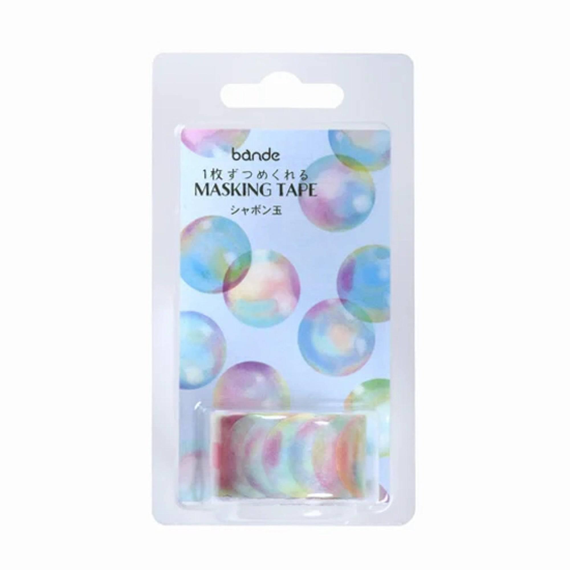 Roll of Soap Bubble Washi Tape stickers, unraveling to reveal its ethereal bubble designs, placed on a wooden desk under soft light.