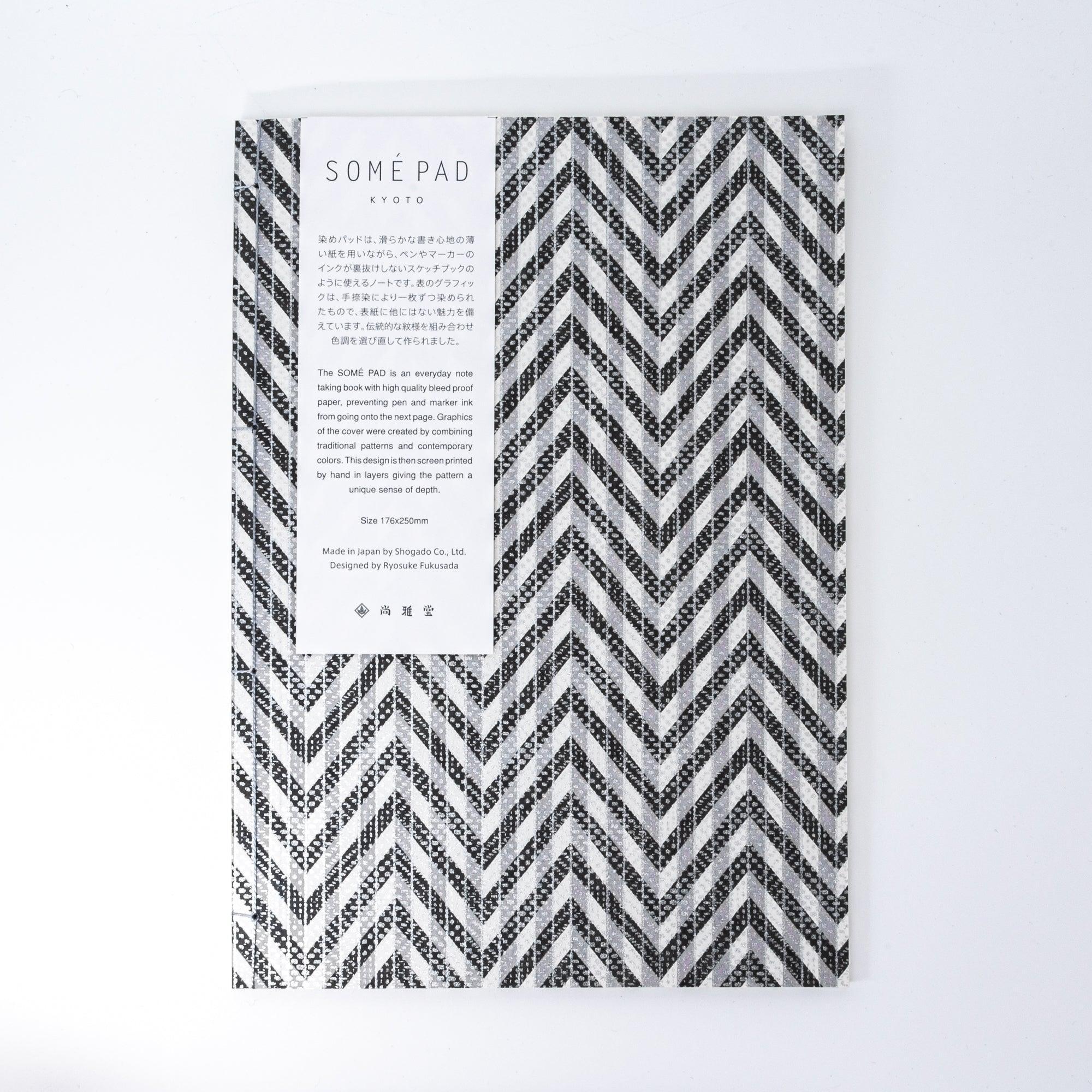 Notebook with a black and gray chevron-patterned cover, screenprinted by hand. Features bleed-proof paper for smooth writing. Made in Japan.
