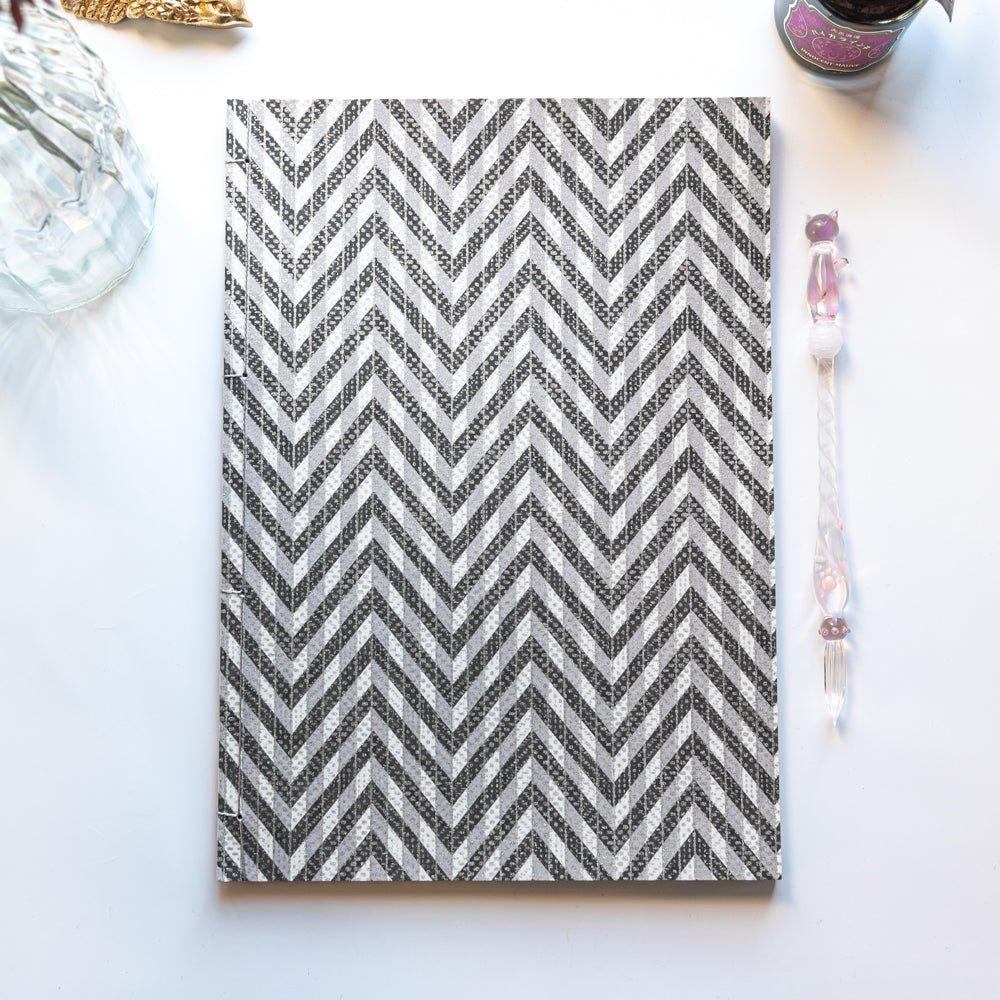 Black Yuzen washi notebook with Japanese stab binding, B5 size, showing rich dark color featuring traditional Japanese design