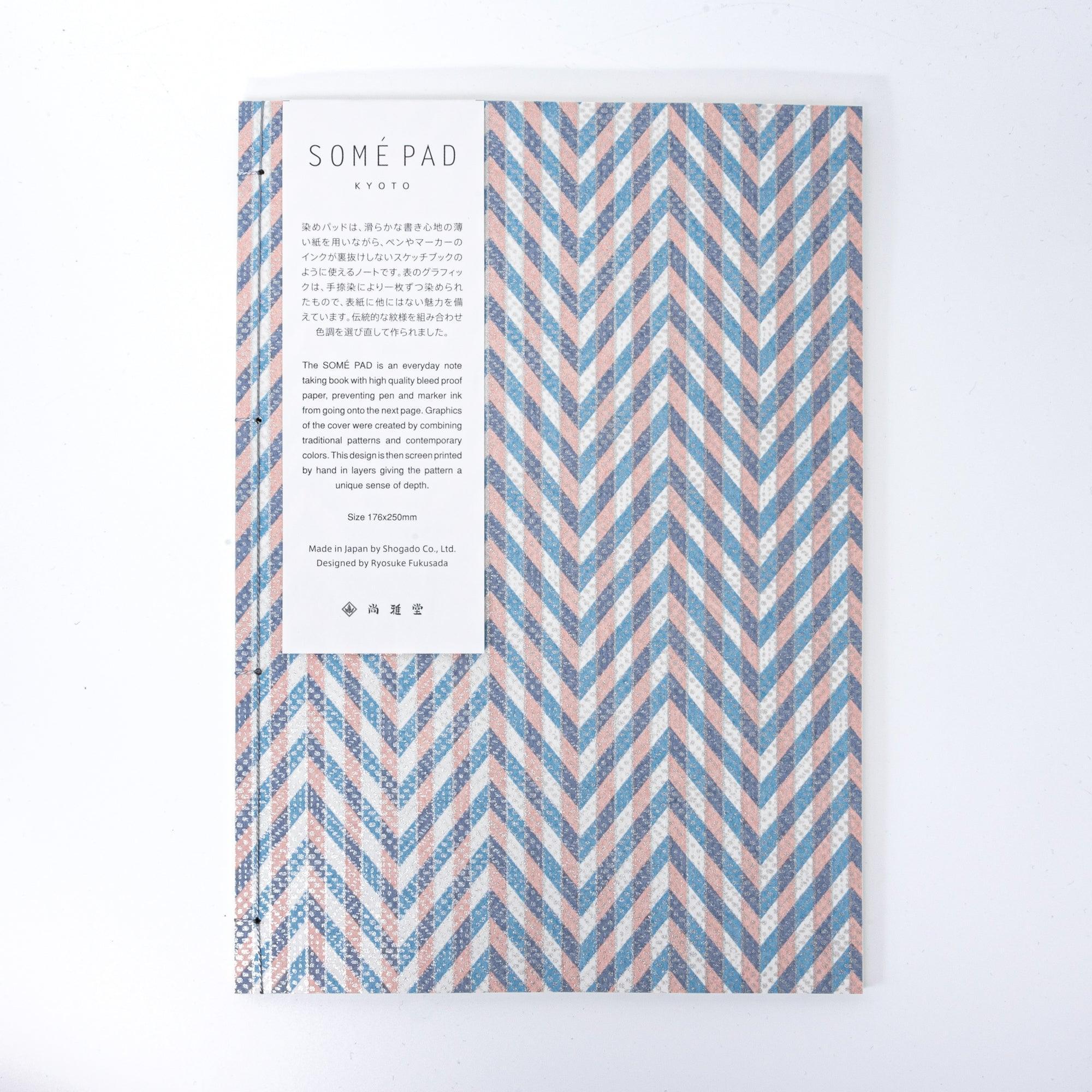 Notebook with a blue and pink chevron-patterned cover, screenprinted by hand. Features bleed-proof paper for smooth writing. Made in Japan.