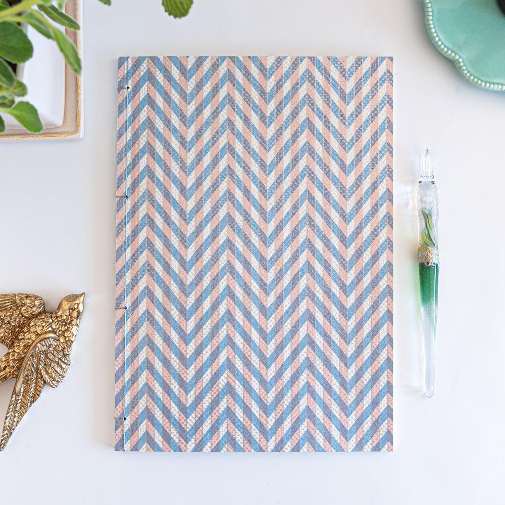 Notebook with a blue and pink chevron-patterned cover, screenprinted by hand. Features bleed-proof paper for smooth writing. Made in Japan.