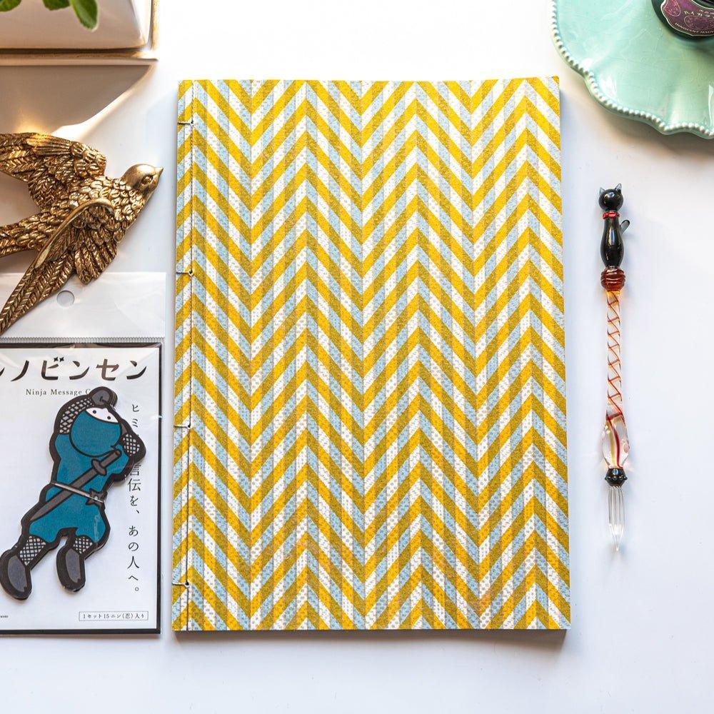 Yellow Yuzen washi notebook with Japanese stab binding, B5 size, showing quality paper featuring traditional Japanese design