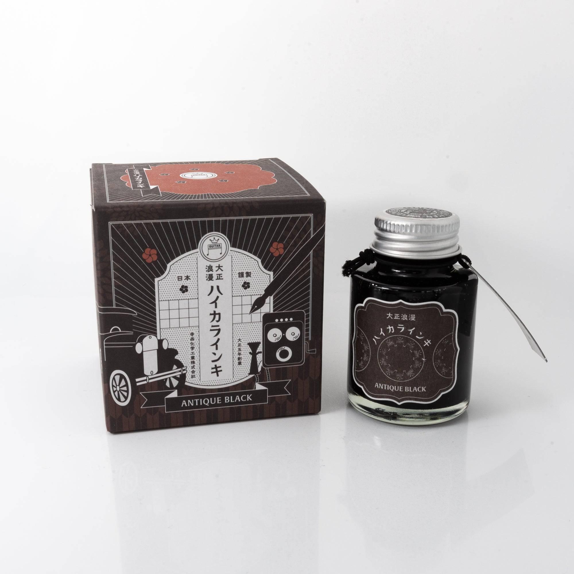 Taisho Romance Antique Black fountain pen ink bottle with a classic black hue, placed on a wooden desk under soft natural light.