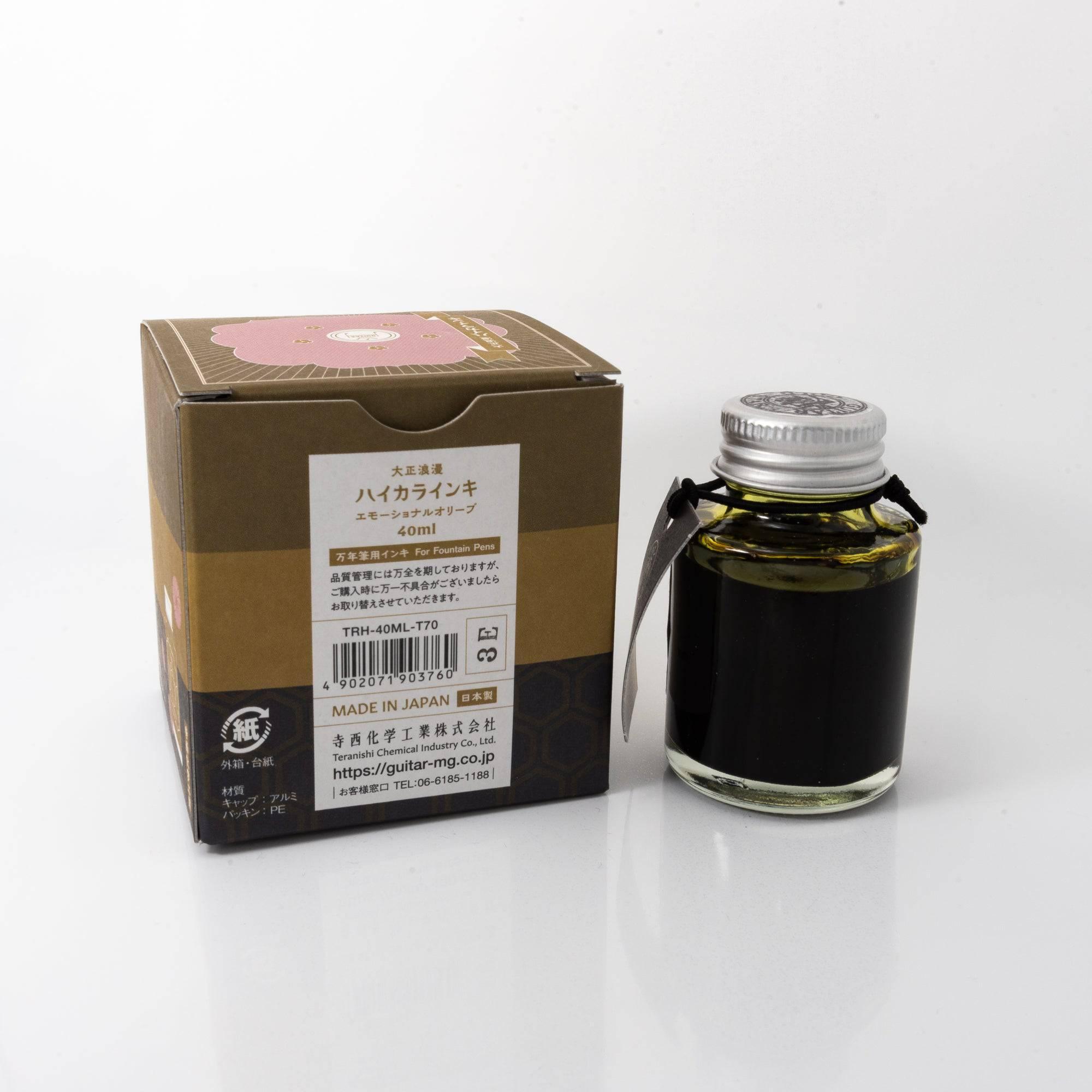 Top view of the Taisho Romance Emotional Olive ink bottle, highlighting its gentle olive ink, surrounded by natural wooden tones.