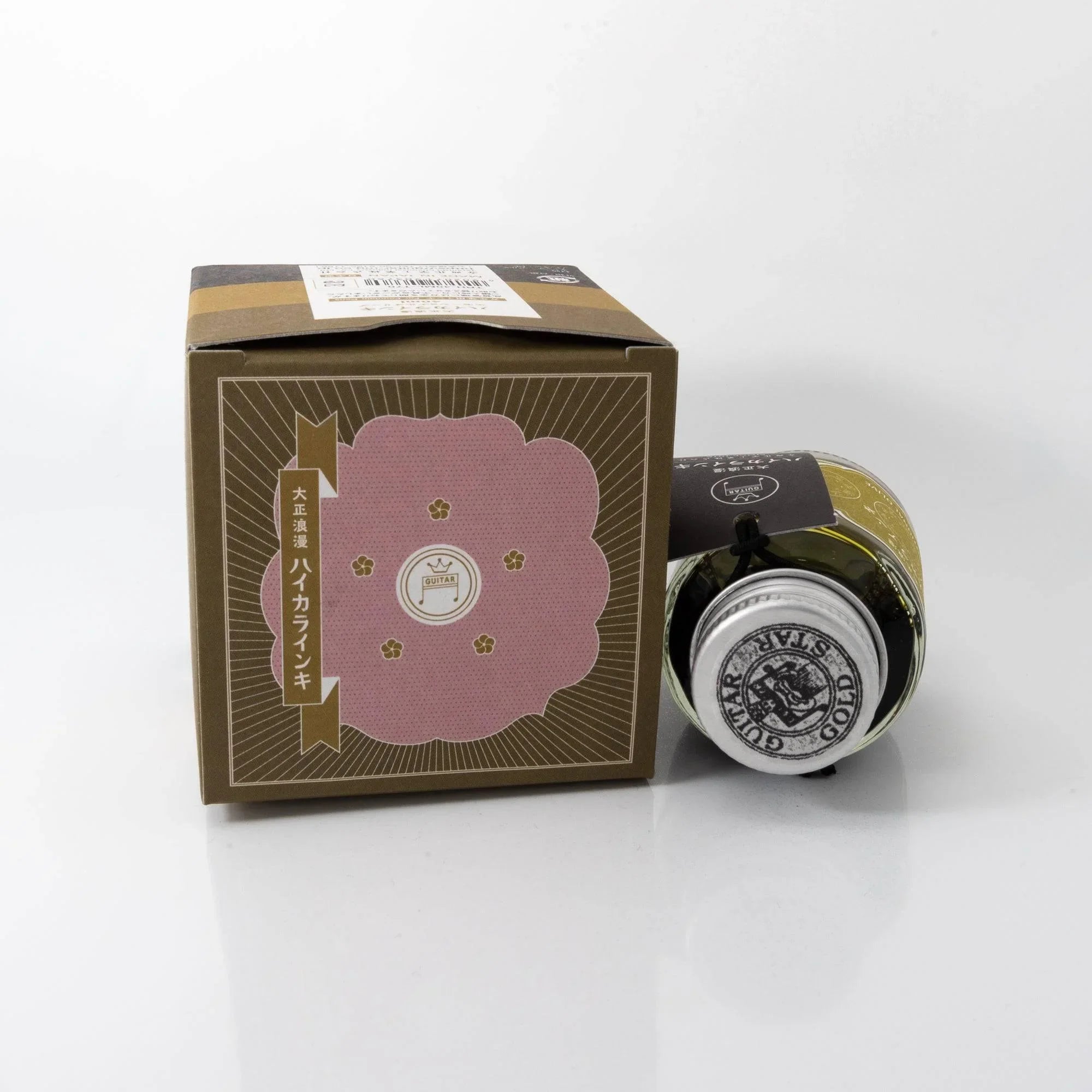 Macro close-up detail view of Taisho Romance Emotional Olive fountain pen ink bottle and label features