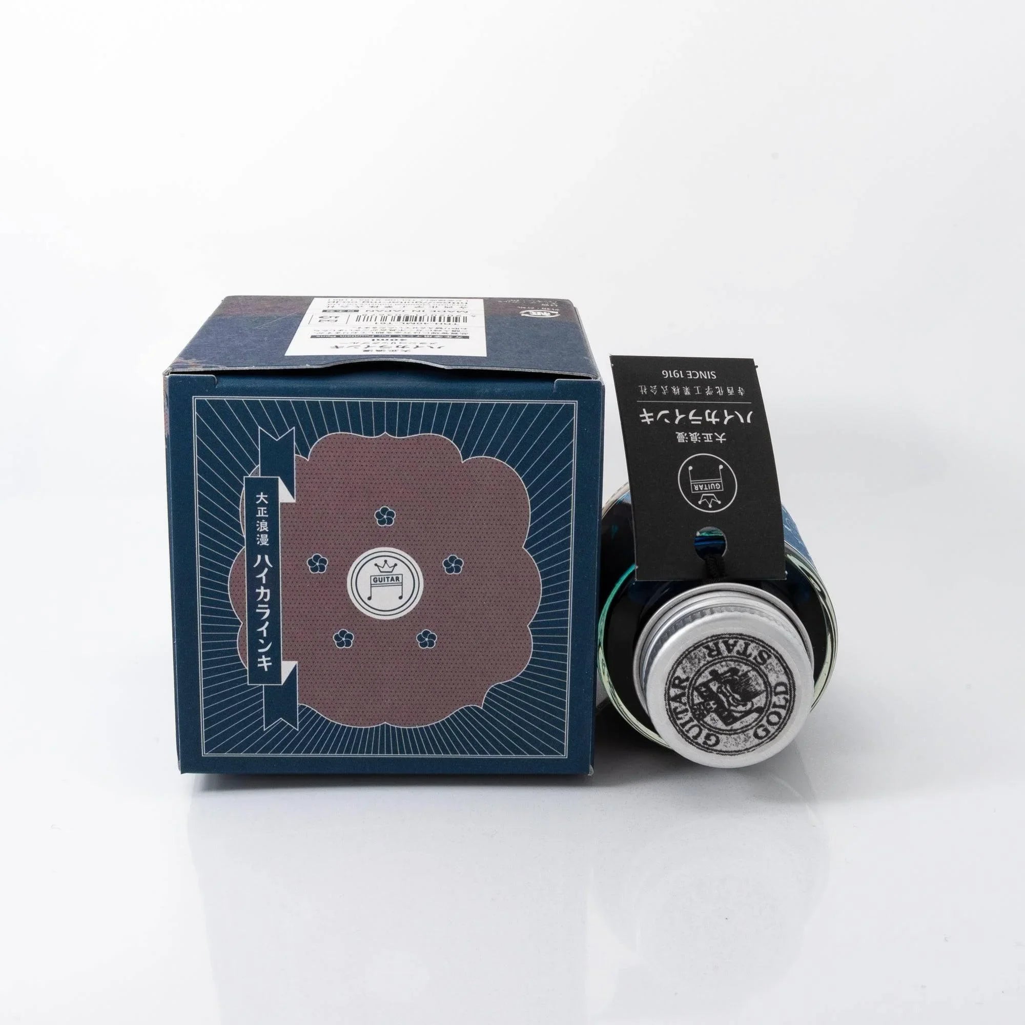 Close-up detail of Taisho Romance Melancholic Blue bottle showing amber glass texture and traditional label shine