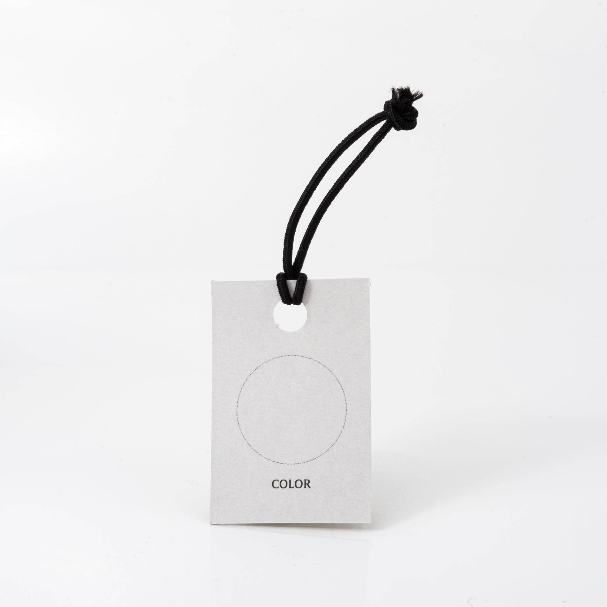 A white tag with a black cord labeled "COLOR," likely for ink testing, complementing the Japanese stationery theme.